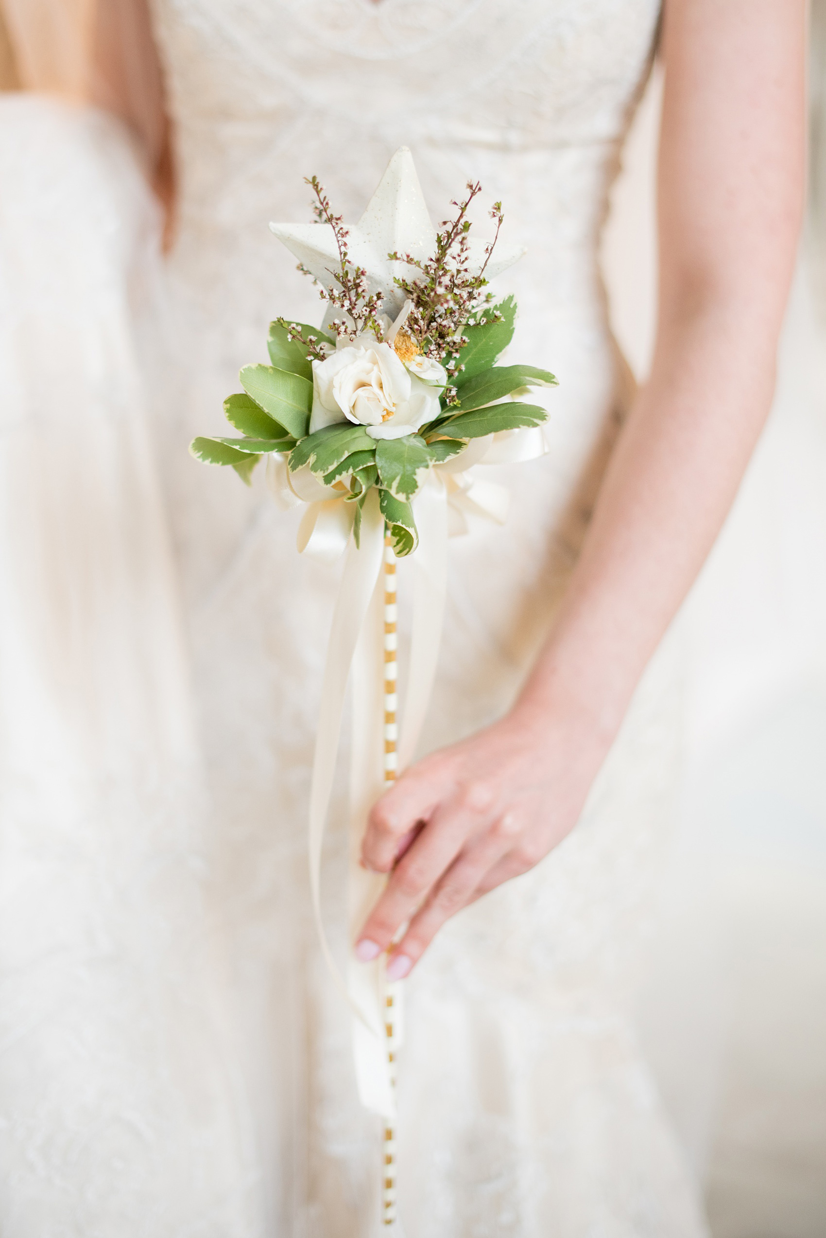 Mikkel Paige Photography photo of a wedding in Chapel Hill at Duke Chapel. Detail picture of the bride holding the flower girl's star wand in lieu of petals.