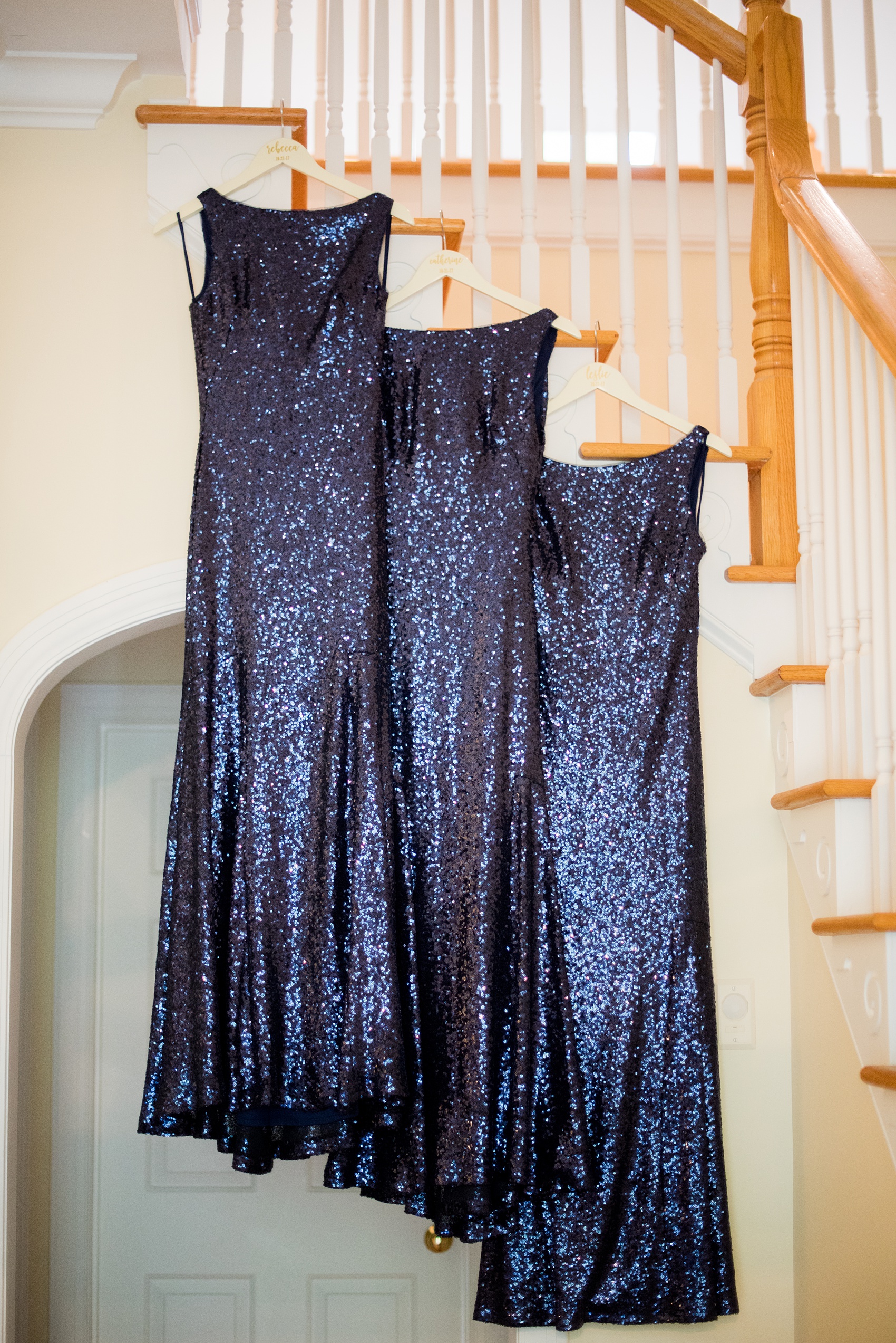 Mikkel Paige Photography photo of a wedding in Chapel Hill at Duke Chapel. Detail picture of the navy blue, low back sequin gowns and custom hangers the bridesmaids wore.