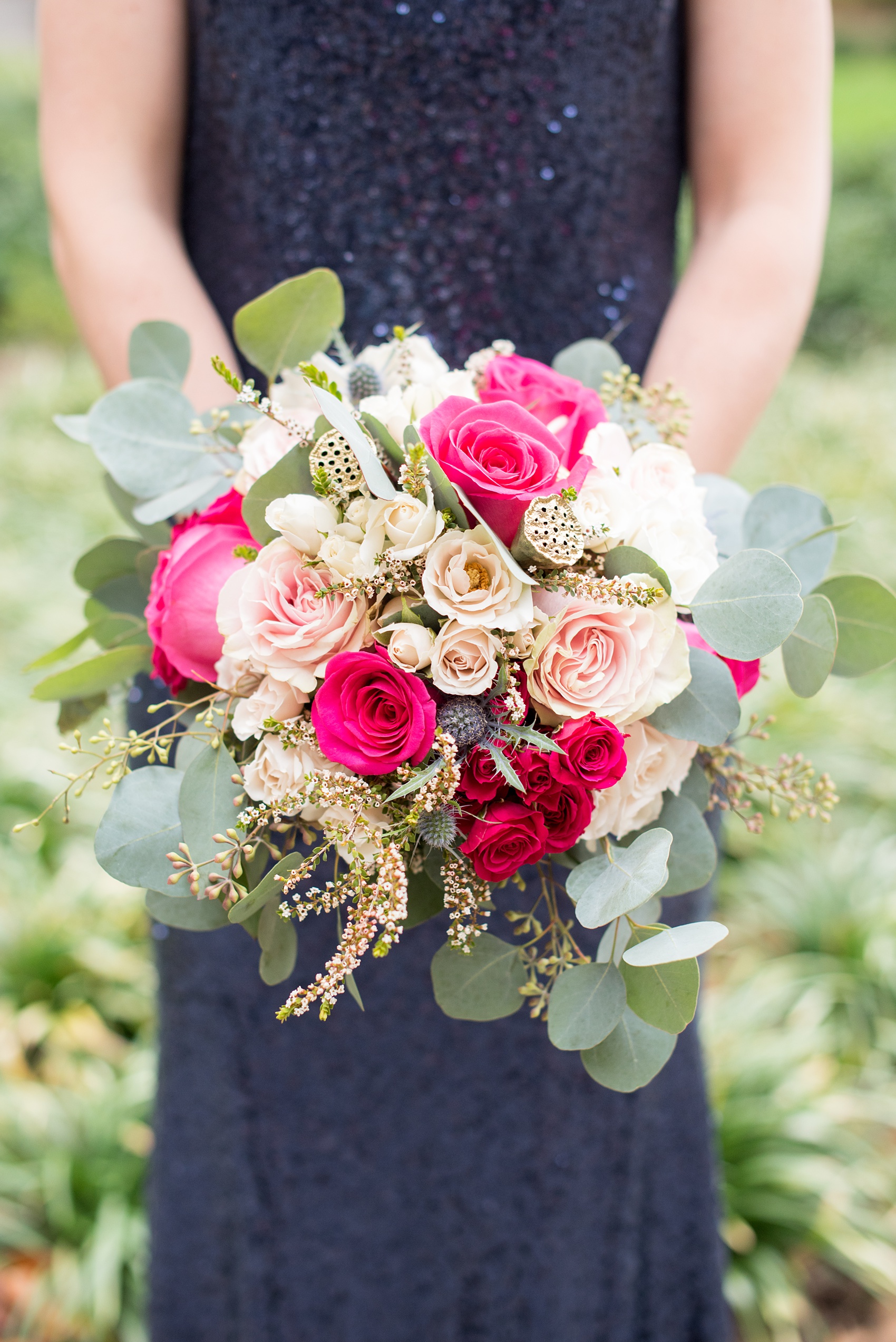 Mikkel Paige Photography photo of a wedding in Chapel Hill at Duke Chapel. Detail picture of the bridesmaids bouquets, with pink, white and fuchsia roses and silver dollar eucalyptus.