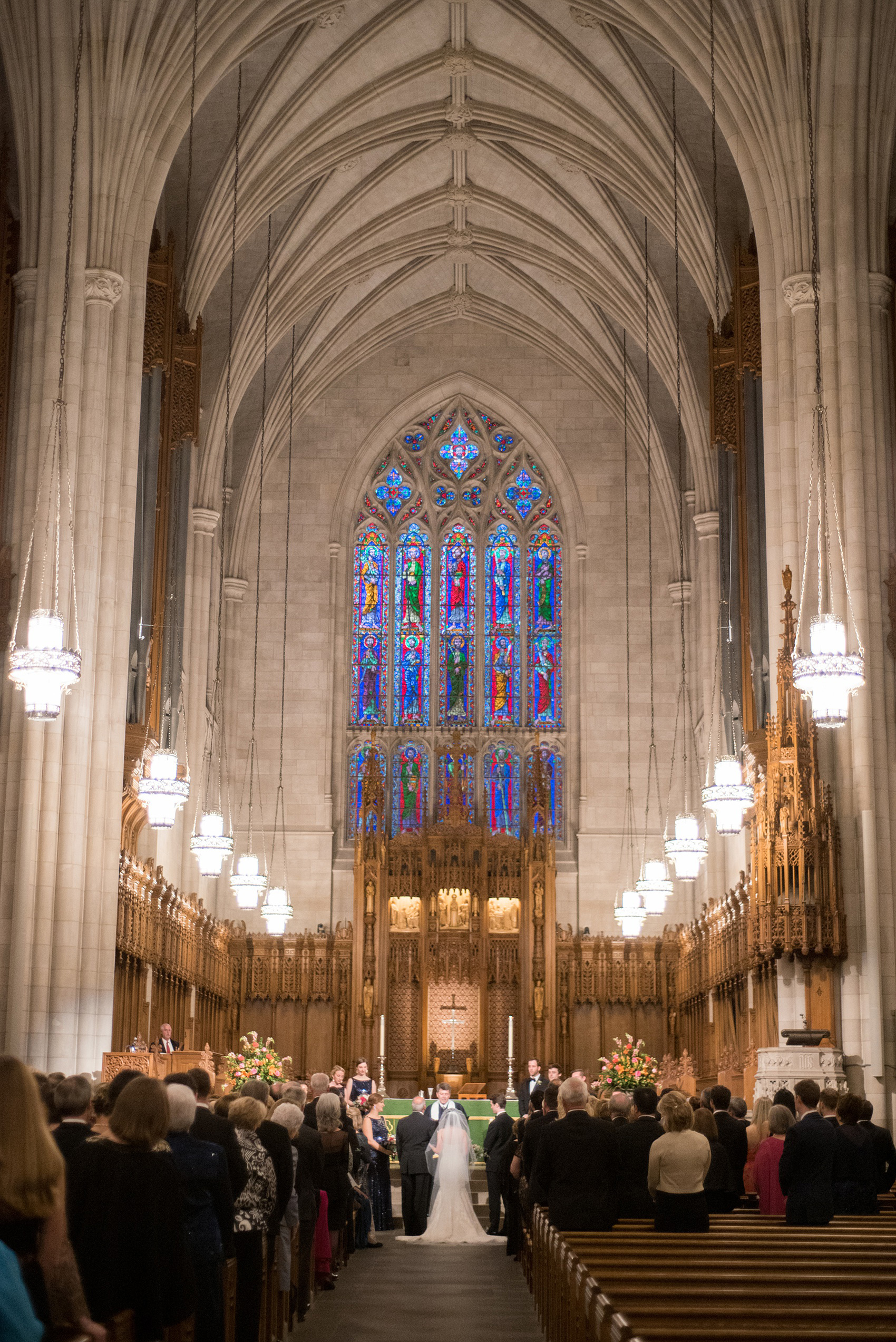 Mikkel Paige Photography photo of a wedding in Chapel Hill at Duke Chapel. Bride and groom with the gothic architecture. Picture of the ceremony inside the church.