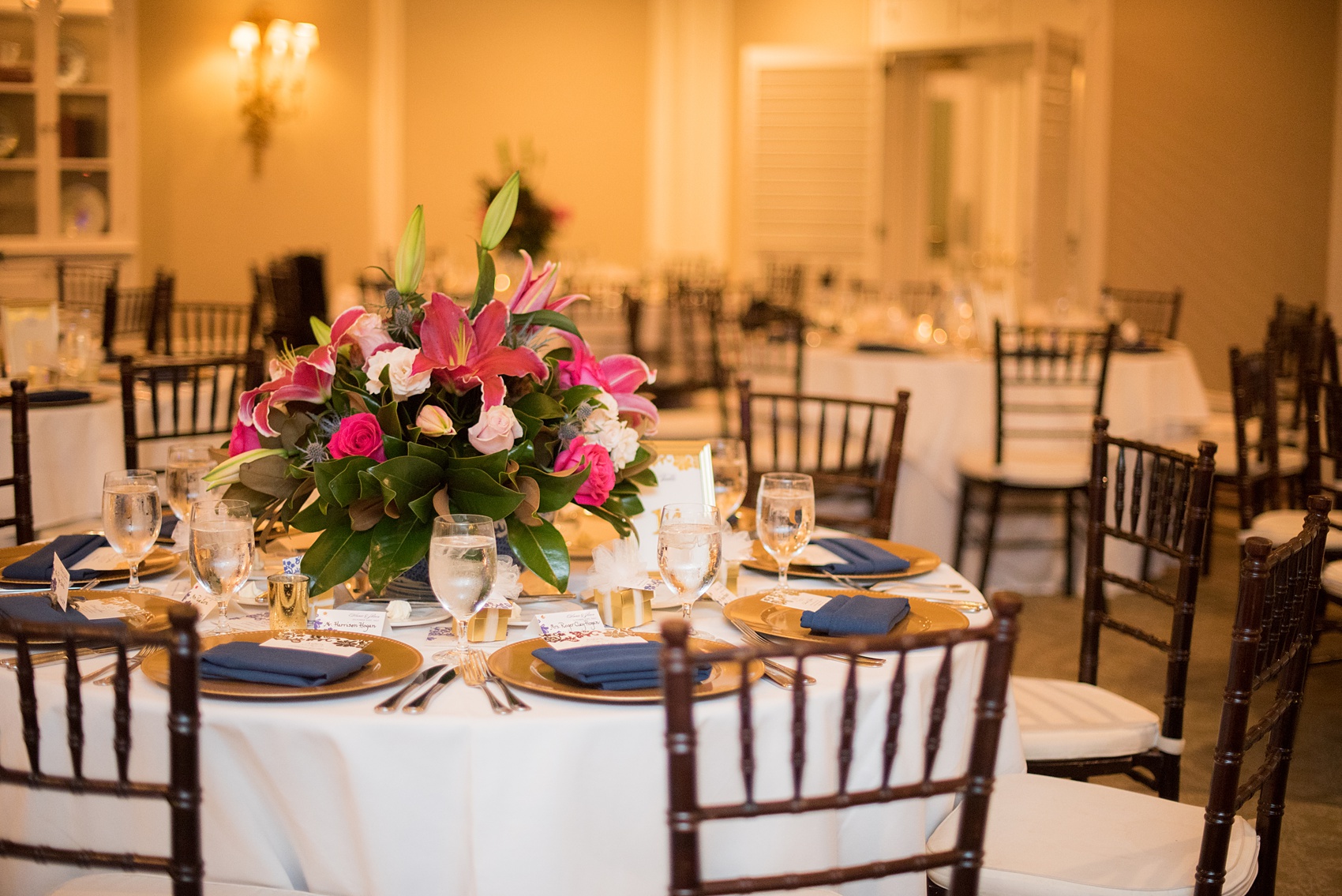 Mikkel Paige Photography photo of a wedding reception at Hope Valley Country Club in Chapel Hill, NC. Picture of the navy blue and gold table settings.