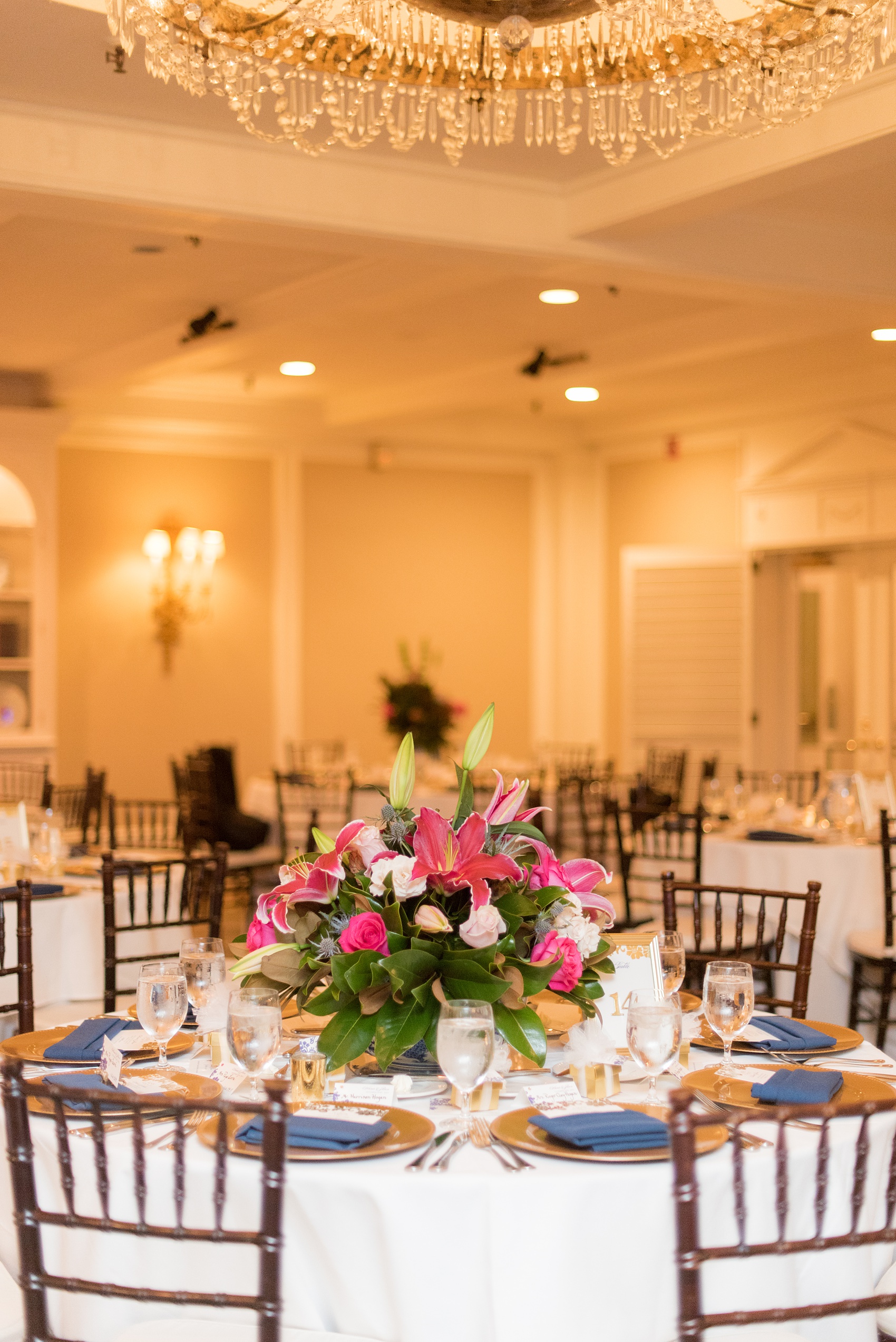 Mikkel Paige Photography photo of a wedding reception at Hope Valley Country Club in Chapel Hill, NC. Picture of the navy blue and gold table settings.