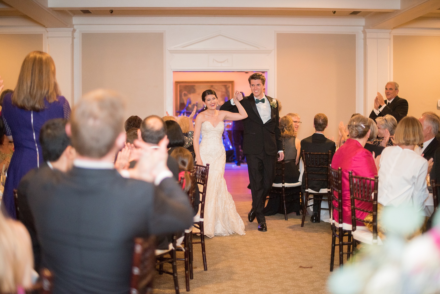 Mikkel Paige Photography photo of a wedding reception at Hope Valley Country Club in Chapel Hill, NC. Picture of the bride and groom entering the dining room.