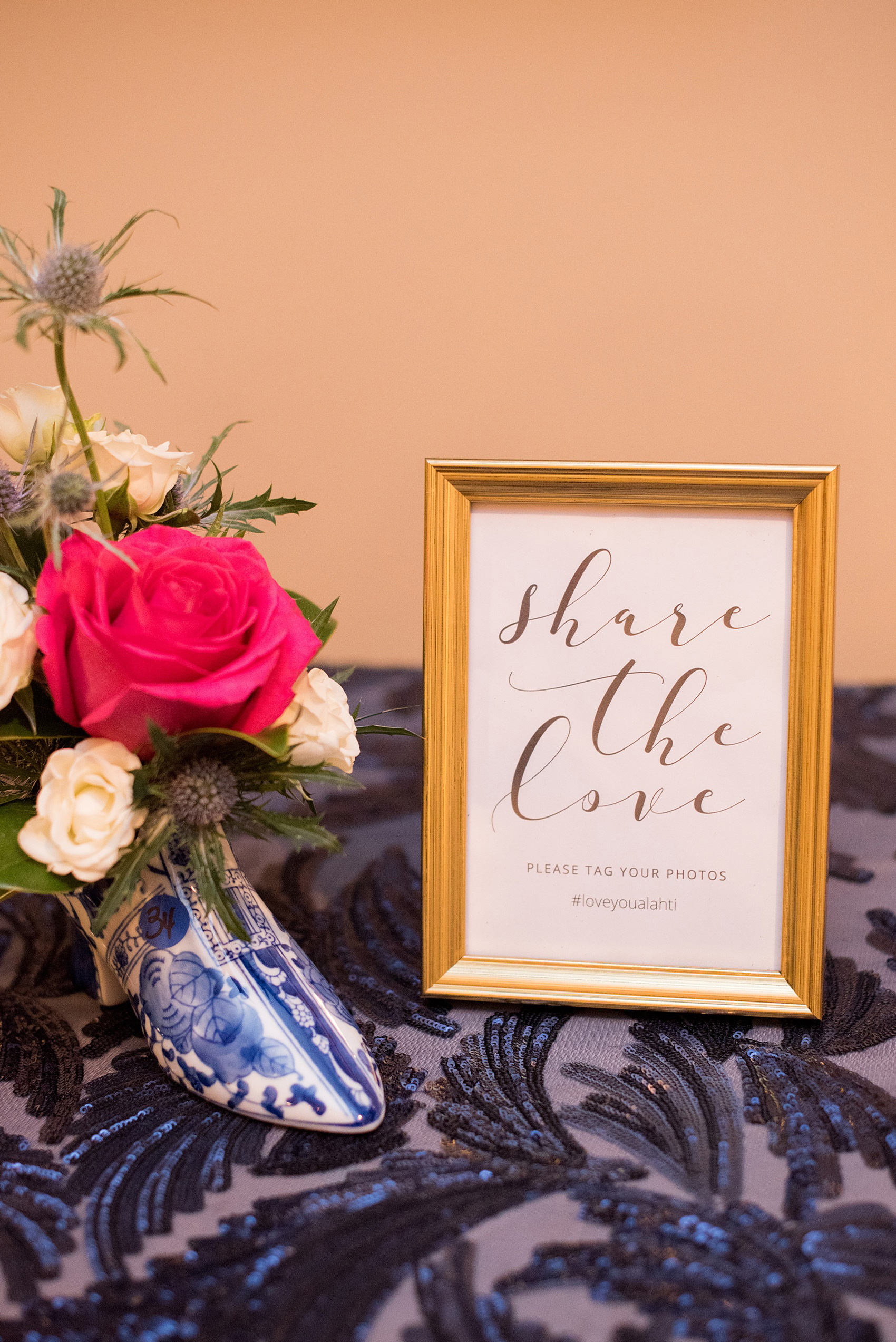 Mikkel Paige Photography photo of a wedding reception at Hope Valley Country Club in Chapel Hill, NC. Picture of the bride and groom's hashtag social media sign and small floral arrangement in a Delftware boot.