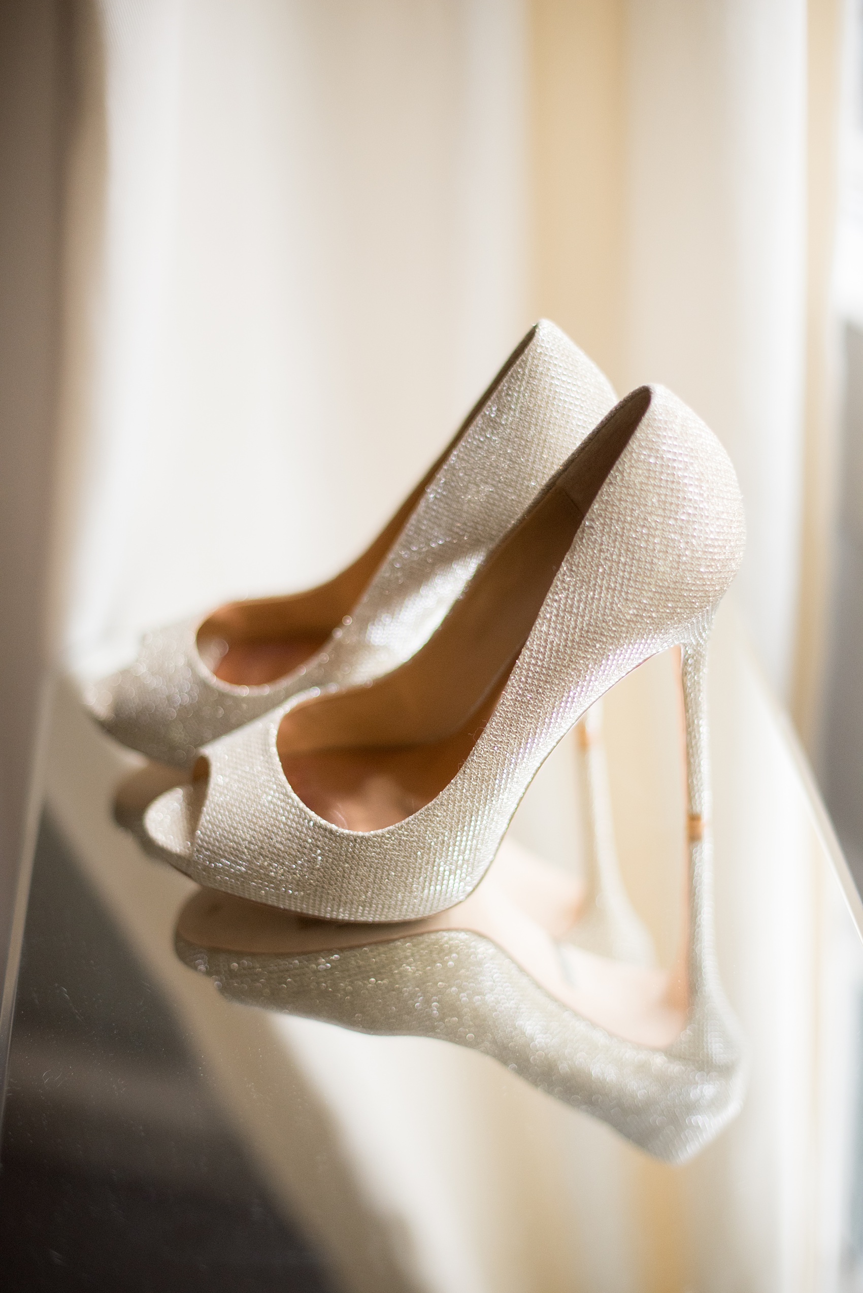 Mikkel Paige Photography photos from a wedding at Leslie-Alford Mims House in North Carolina. Picture of the bride's metallic gold Badgley Mischka heels.