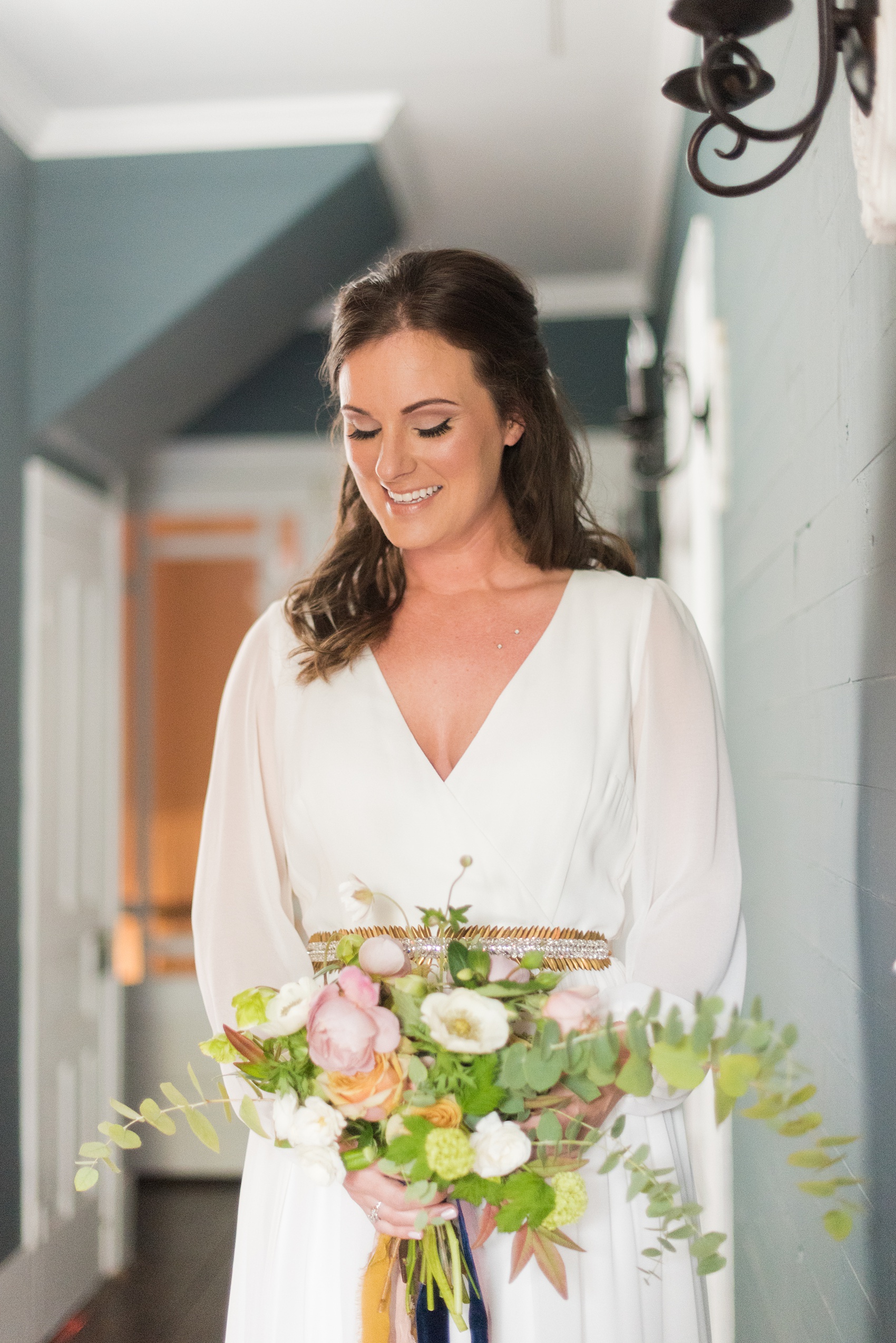 Mikkel Paige Photography photos from a wedding at Leslie-Alford Mims House in North Carolina. Picture of the bride holding her fall bouquet for her Mad Dash Wedding.