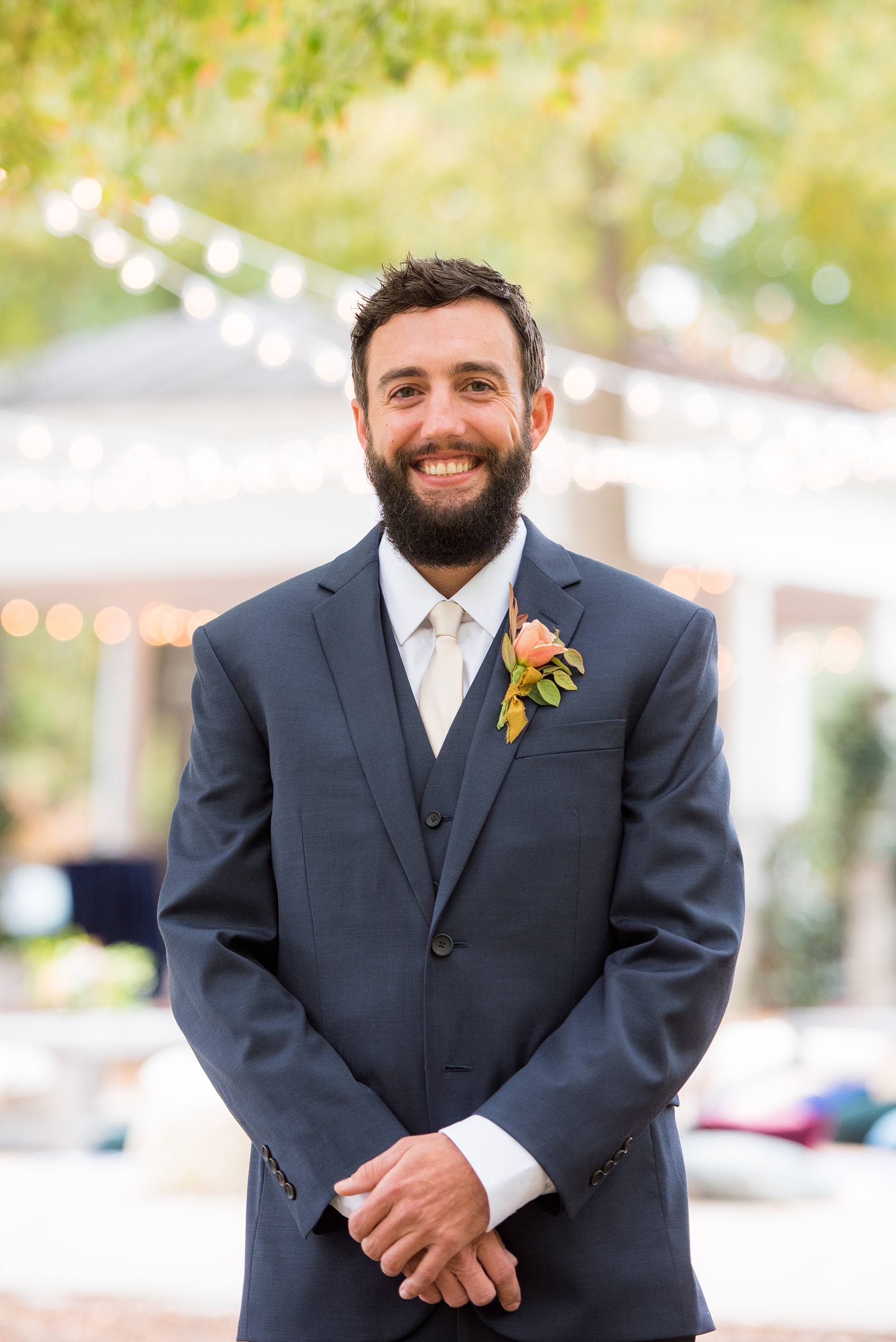 Mikkel Paige Photography photos from a wedding at Leslie-Alford Mims House in North Carolina. Picture of the groom in a navy blue double breasted suit and fall boutonniere at his Mad Dash Wedding.