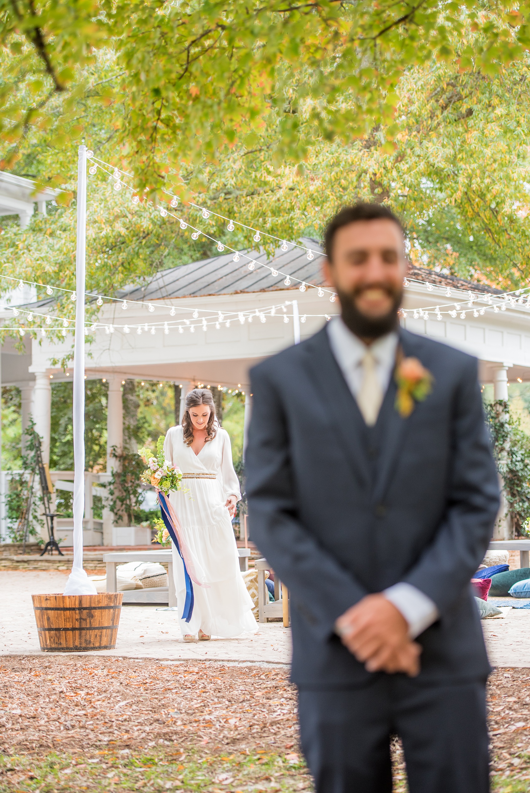 Mikkel Paige Photography photos from a wedding at Leslie-Alford Mims House in North Carolina. Picture of the bride walking towards the groom for their outdoor fall first look.