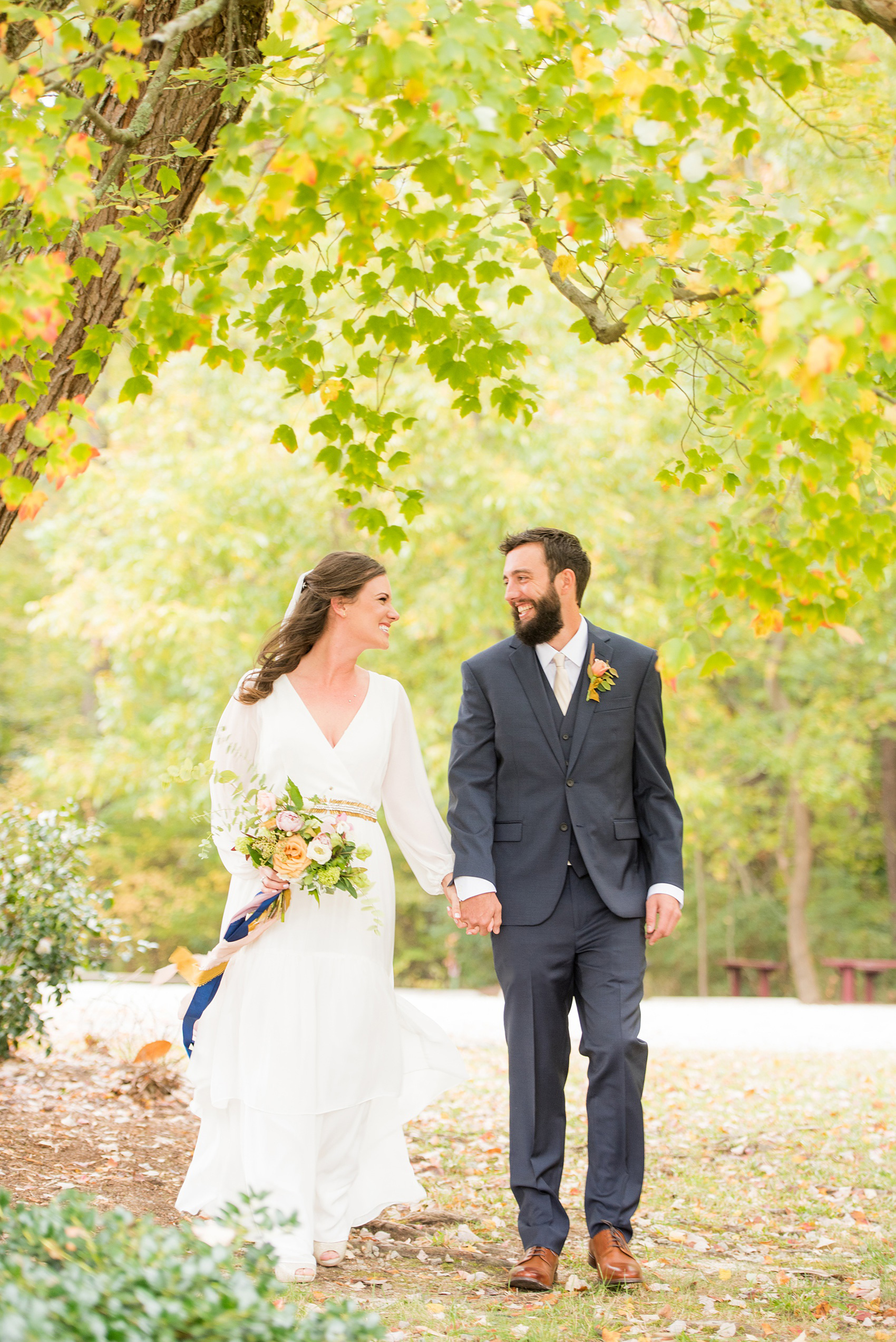 Mikkel Paige Photography photos from a wedding at Leslie-Alford Mims House in North Carolina. Picture of the Boho bride and groom in a navy suit for their fall day.