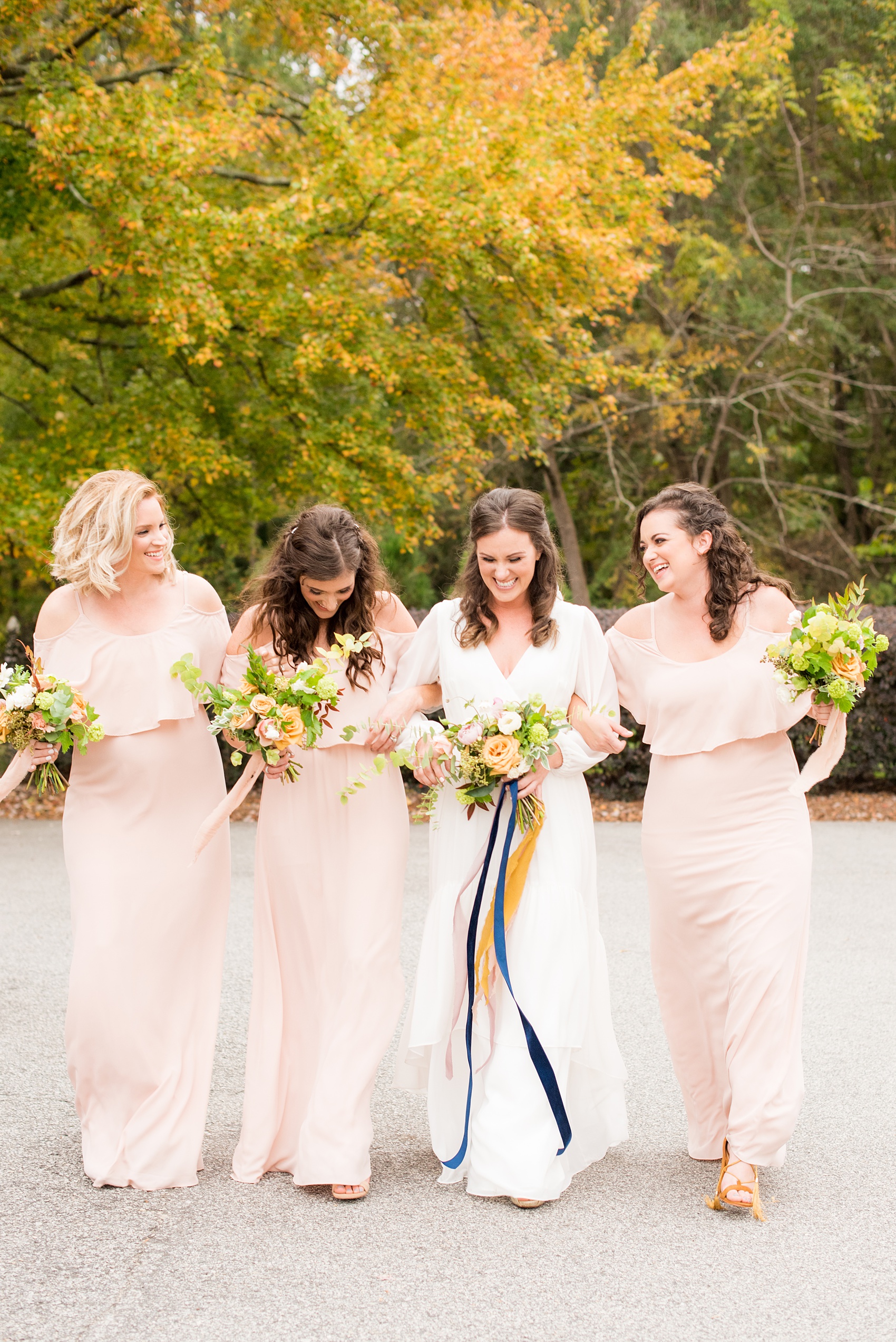 Mikkel Paige Photography photos from a wedding at Leslie-Alford Mims House in North Carolina. Picture of the bridal party in light pink, off-the-shoulder, chiffon dresses for a fall Mad Dash Weddings event.