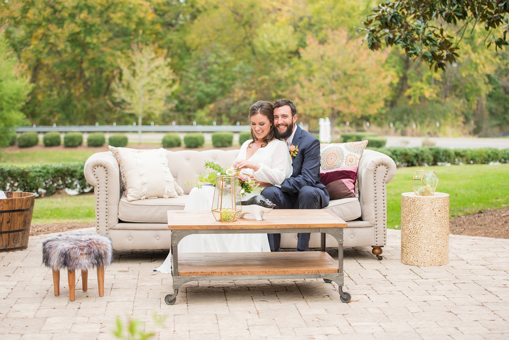 Mikkel Paige Photography photos from a wedding at Leslie-Alford Mims House in North Carolina. Photo of the bride and groom on their outdoor reception lounge furniture from Greenhouse Picker Sisters for a Mad Dash Weddings event.