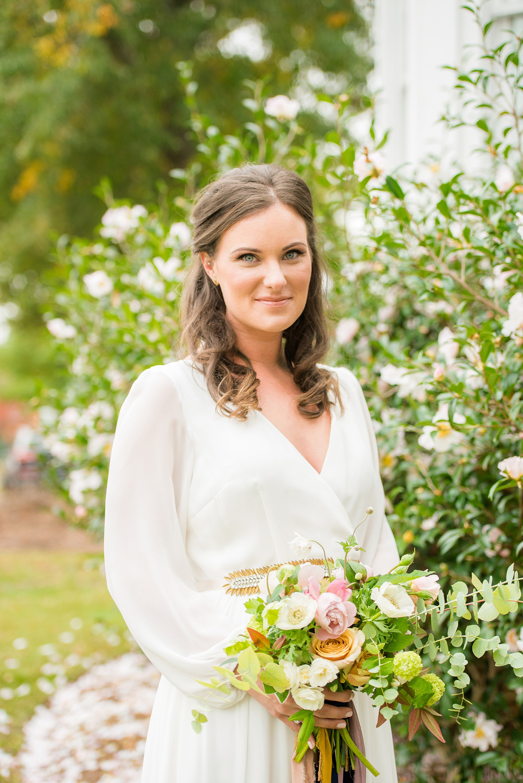 Mikkel Paige Photography photos from a wedding at Leslie-Alford Mims House in North Carolina. Portrait photo of the bride in her long-sleeve, white chiffon gown from BHLDN and fall flowers with long, autumn ribbons by Caroline Ruth Designs for a Mad Dash Wedding.