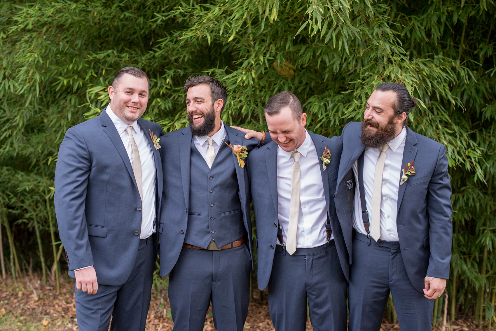 Mikkel Paige Photography photos from a wedding at Leslie-Alford Mims House in North Carolina. Candid picture of the groomsmen in navy blue linen suits for a fall Mad Dash Weddings event.