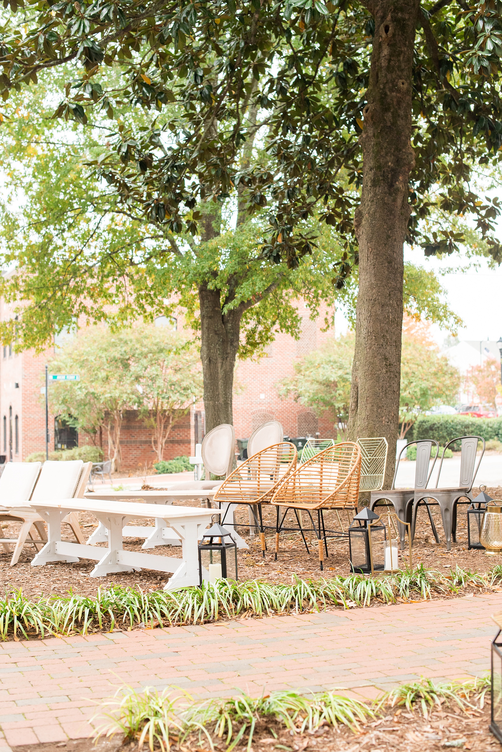 Mikkel Paige Photography photos from a wedding at Leslie-Alford Mims House in North Carolina. Picture of the outdoor ceremony with mixed chairs and benches for nuptials at the historic southern home.