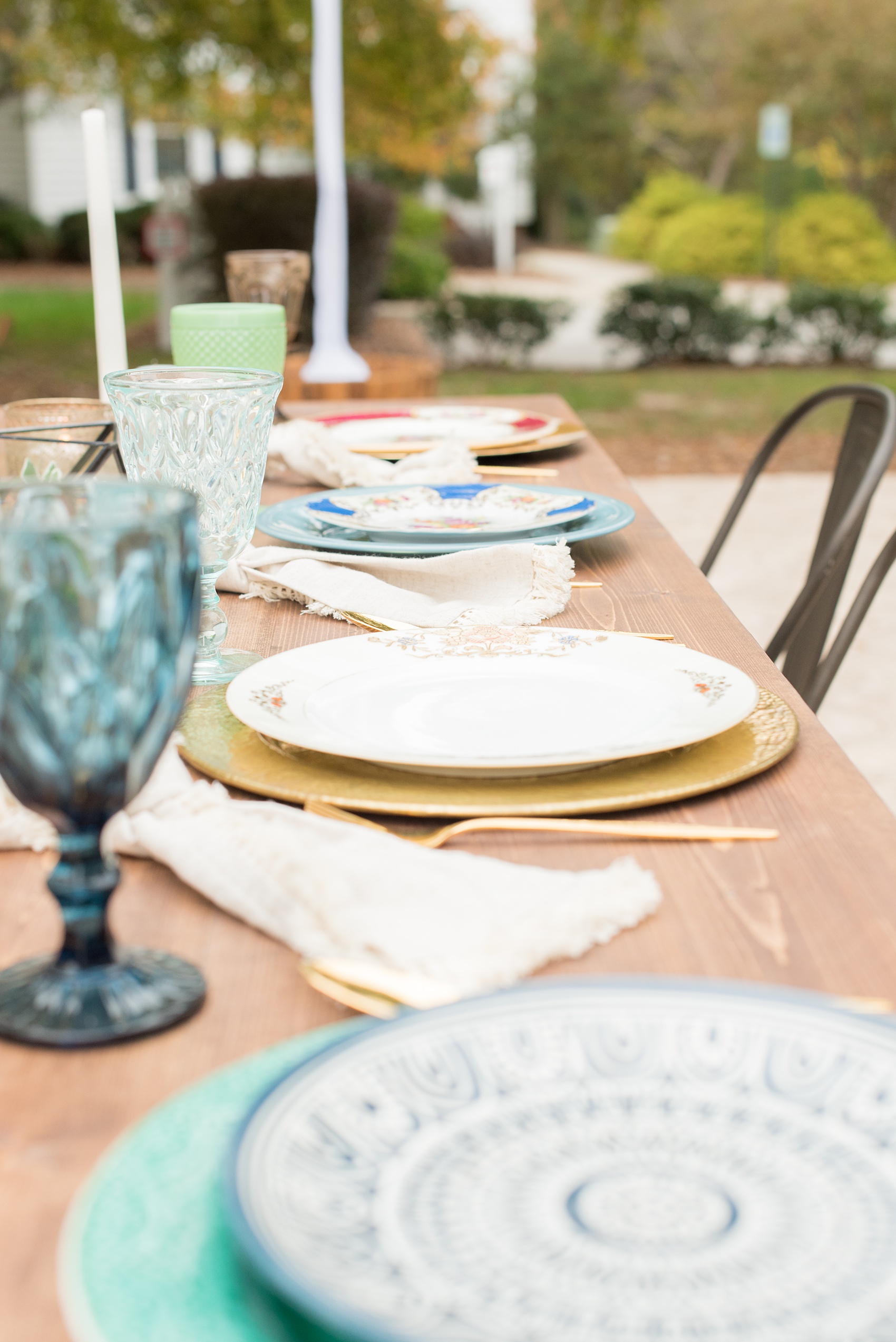 Mikkel Paige Photography photos from a wedding at Leslie-Alford Mims House in North Carolina. Picture of one of the farm tables at the outdoor reception, complete with geodes, green milk glass and mixed table settings.