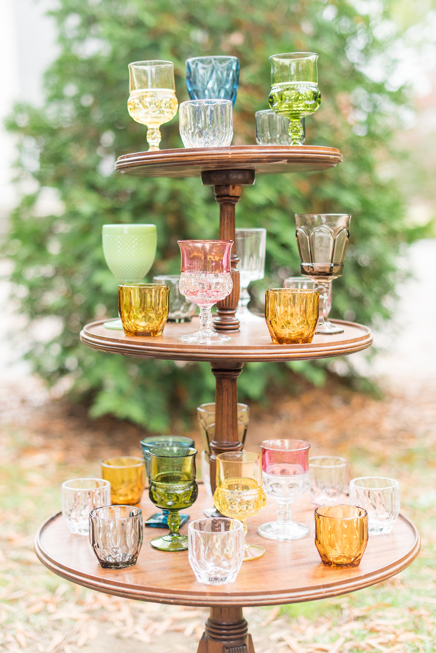 Mikkel Paige Photography photos from a wedding at Leslie-Alford Mims House in North Carolina. Picture of the mixed colored vintage glasses display.