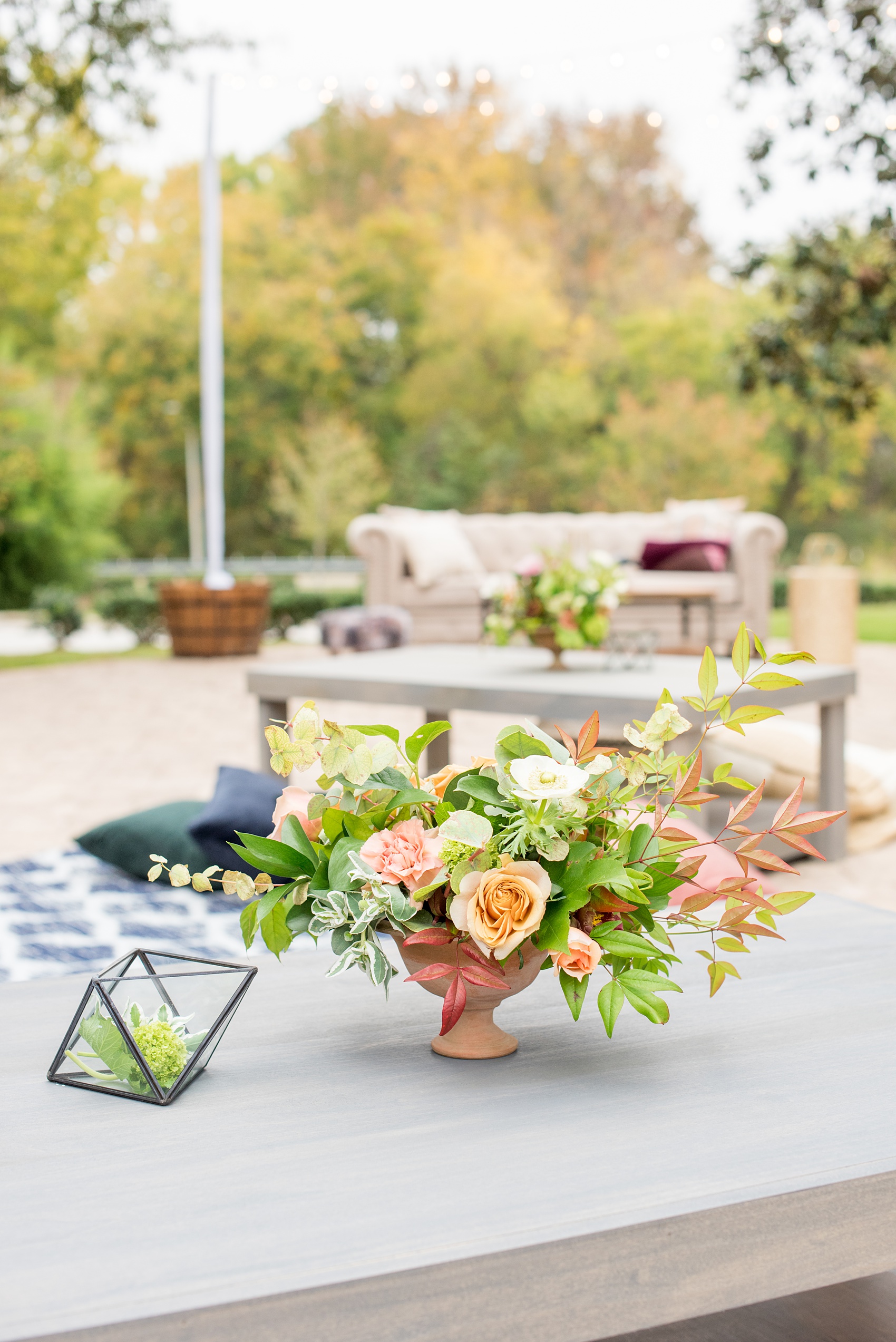 Mikkel Paige Photography photos from a wedding at Leslie-Alford Mims House in North Carolina. Picture of the outdoor reception flowers and low coffee table for a unique, boho reception.