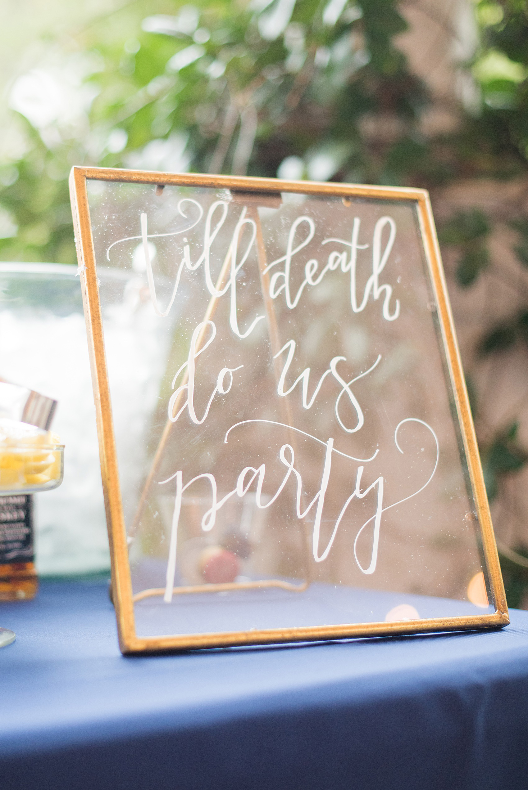 Mikkel Paige Photography photos from a wedding at Leslie-Alford Mims House in North Carolina. Picture of the "Til Death do Us Party" glass calligraphy bar sign.