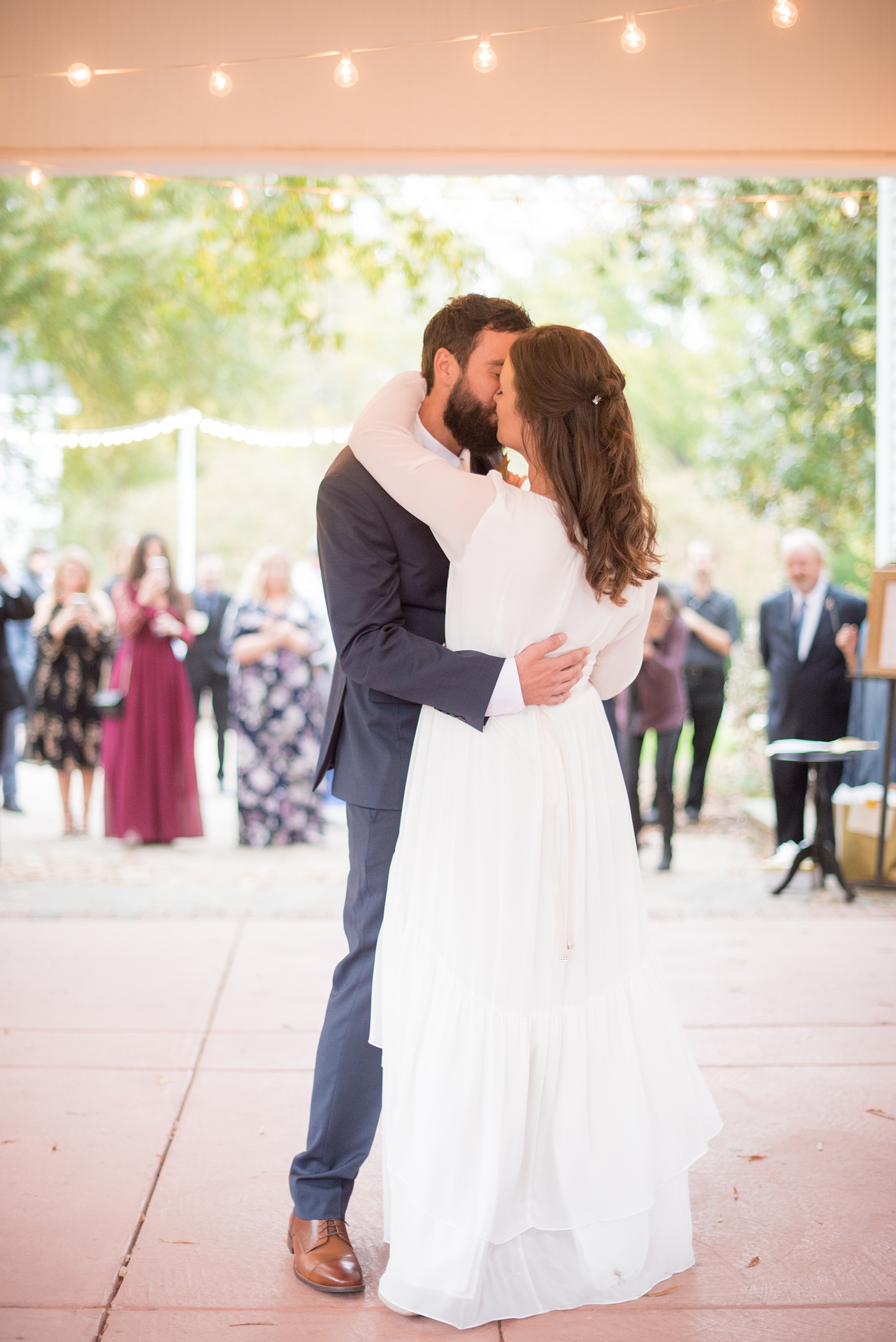 Mikkel Paige Photography photos from a wedding at Leslie-Alford Mims House in North Carolina. Picture of a the bride and groom's first dance at their outdoor reception, to Lana Del Ray's Once Upon a Dream.