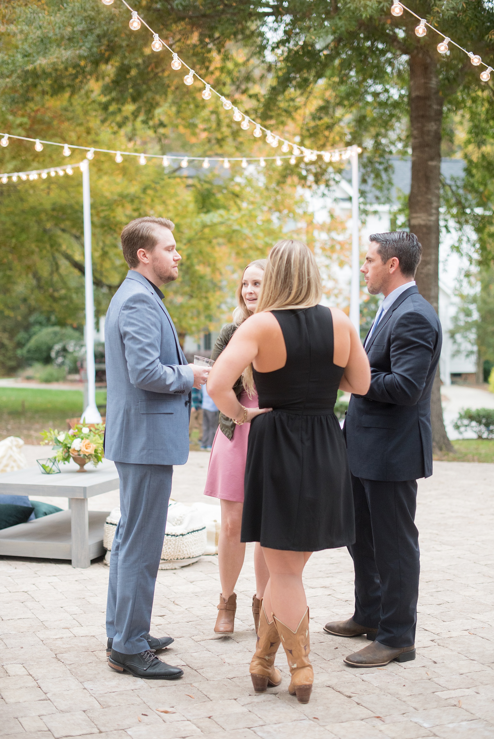 Mikkel Paige Photography photos from a wedding at Leslie-Alford Mims House in North Carolina. Candid picture of the guests enjoying the outdoor reception.