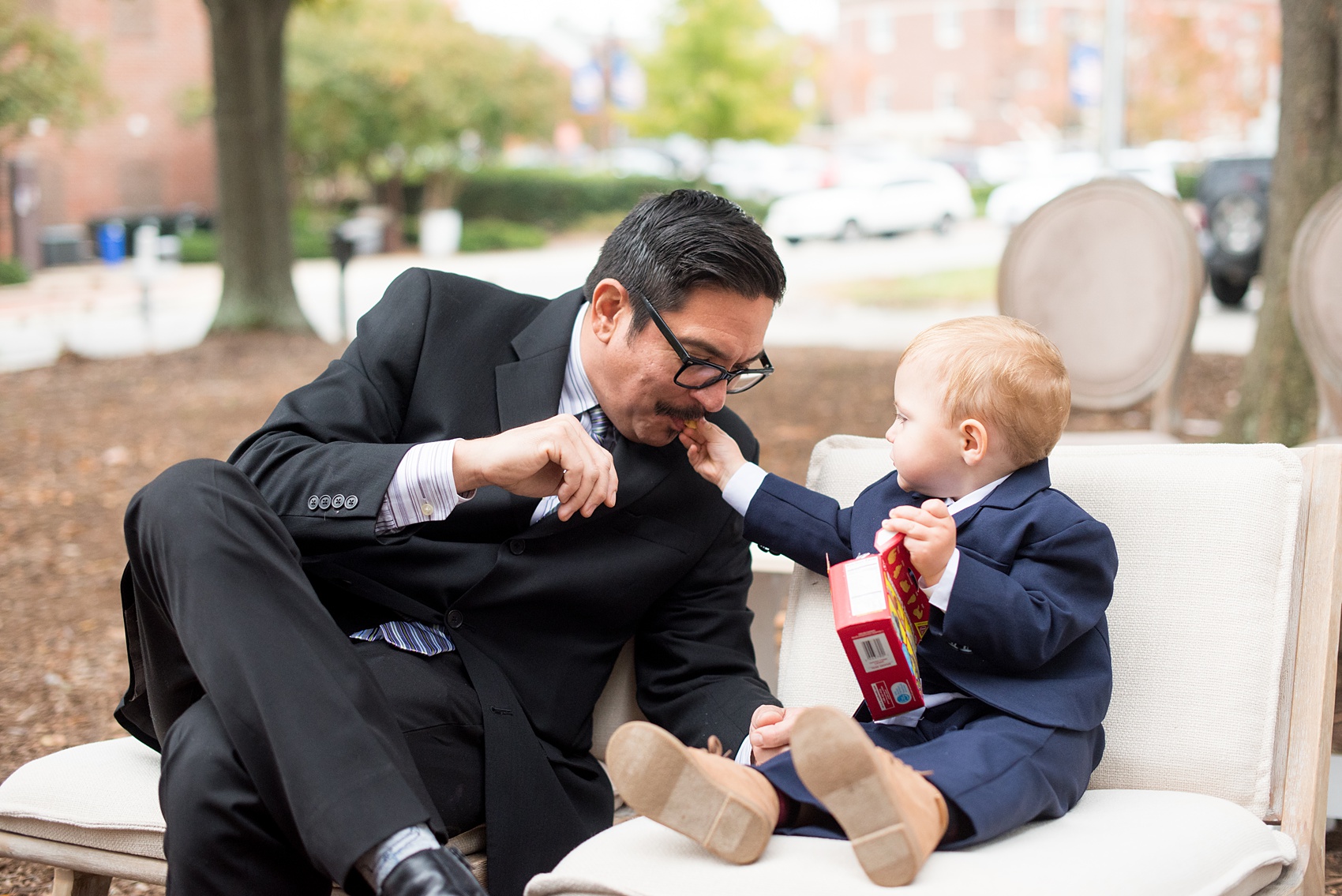 Mikkel Paige Photography photos from a wedding at Leslie-Alford Mims House in North Carolina. Candid picture of the ring bearer feeding a guest animal crackers.