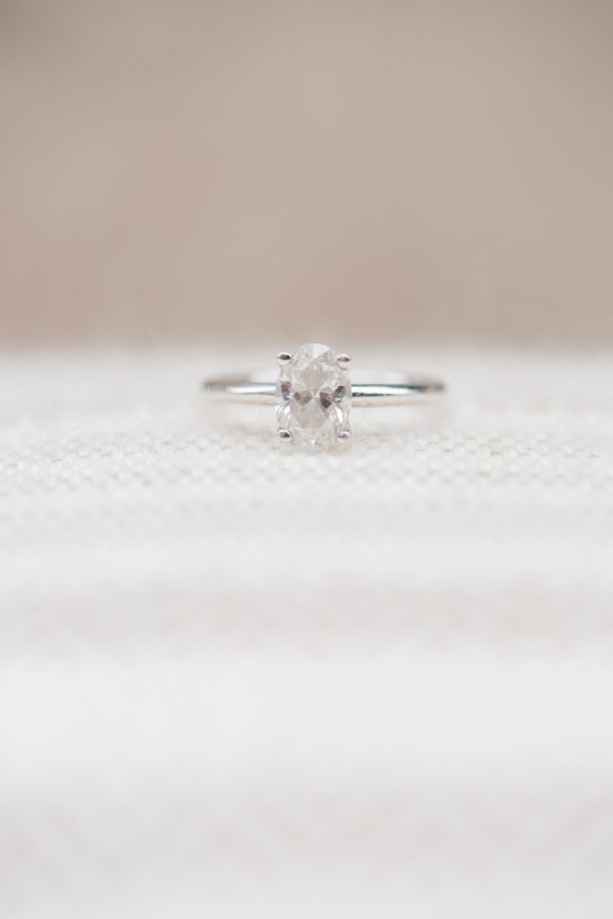 Mikkel Paige Photography pictures of an engagement session in Tribeca. A detail photo of the bride's oval shaped diamond engagement ring.