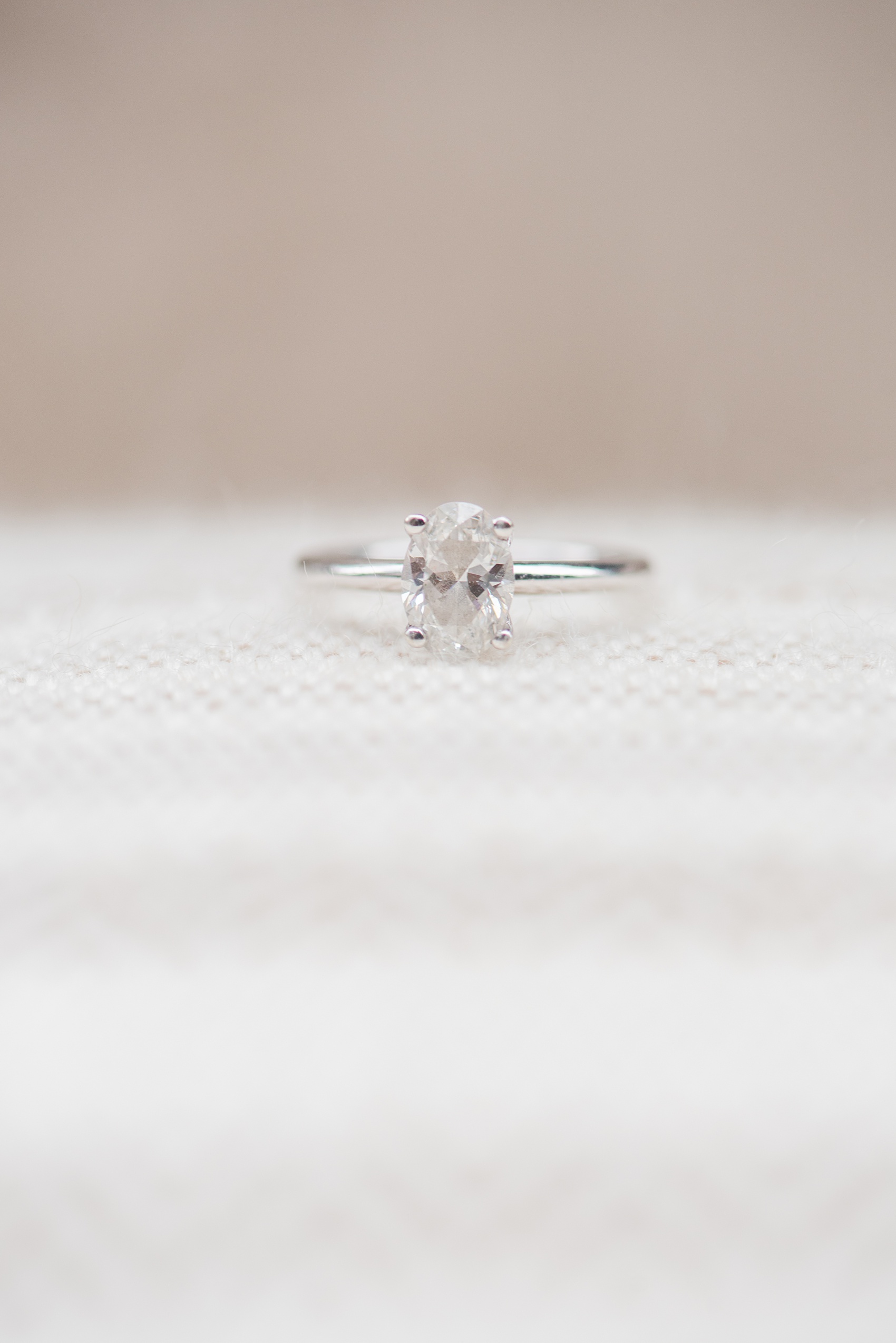 Mikkel Paige Photography pictures of an engagement session in Tribeca. A detail photo of the bride's oval shaped diamond engagement ring.