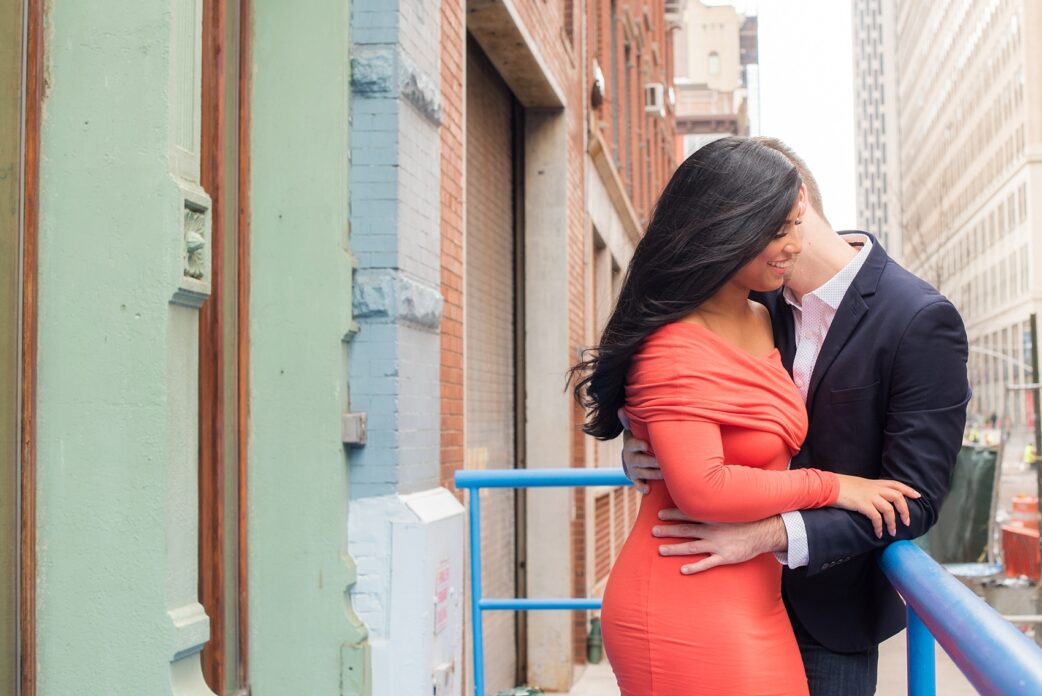 Mikkel Paige Photography pictures of an engagement session in Tribeca. A photo of the couple with lower Manhattan architecture.
