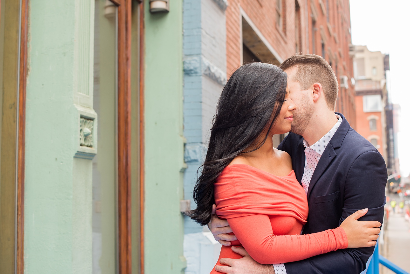 Mikkel Paige Photography pictures of an engagement session in Tribeca. A photo of the couple with lower Manhattan architecture.