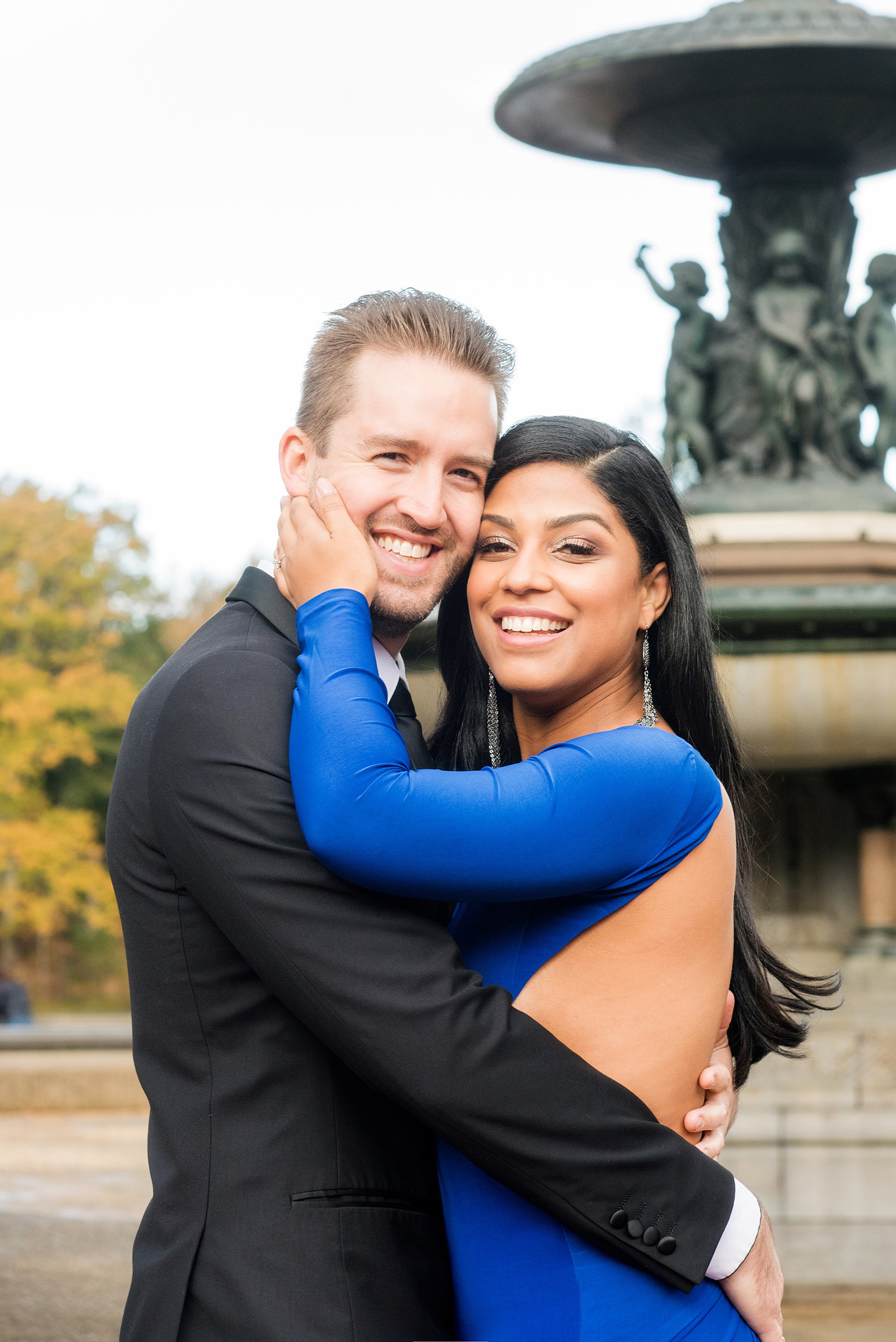 Mikkel Paige Photography pictures of an engagement session in Central Park. A photo of the bride and groom in formal attire by Bethesda Fountain.