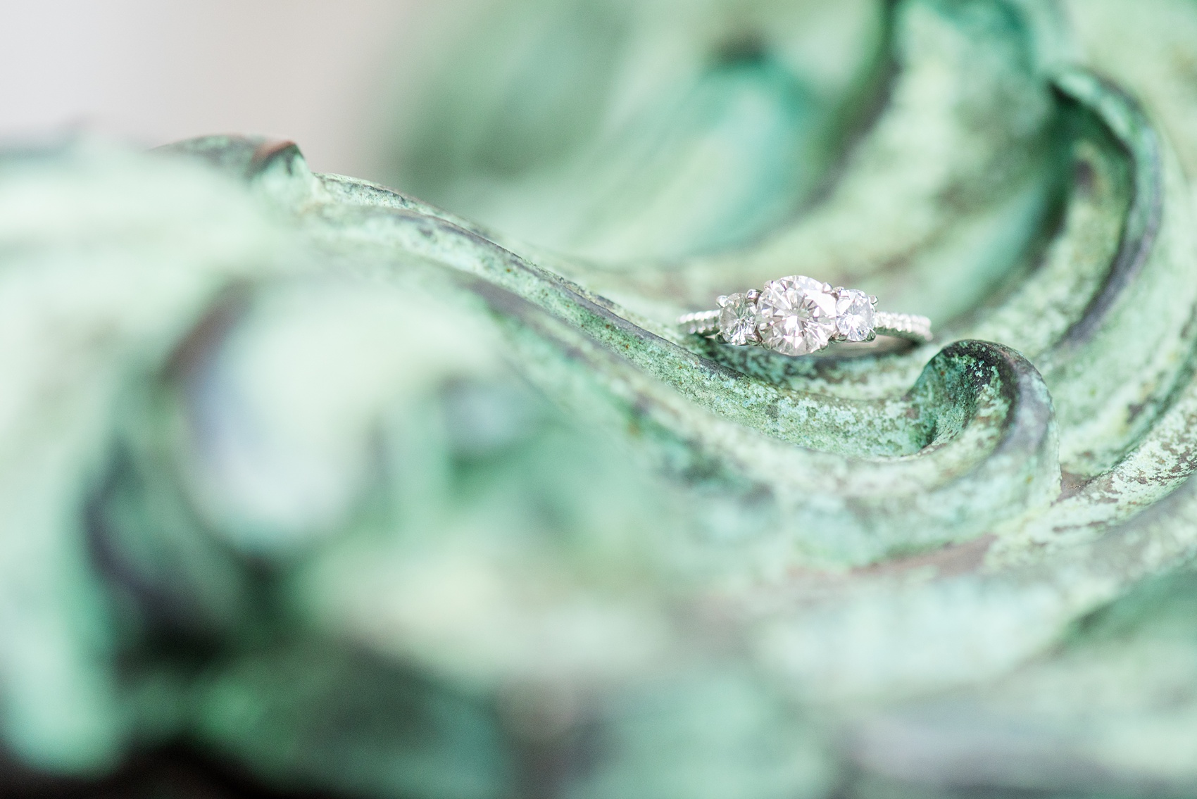 Mikkel Paige Photography engagement photos in lower manhattan near City Hall and the Brooklyn Bridge. Detail picture of the three stone diamond ring.