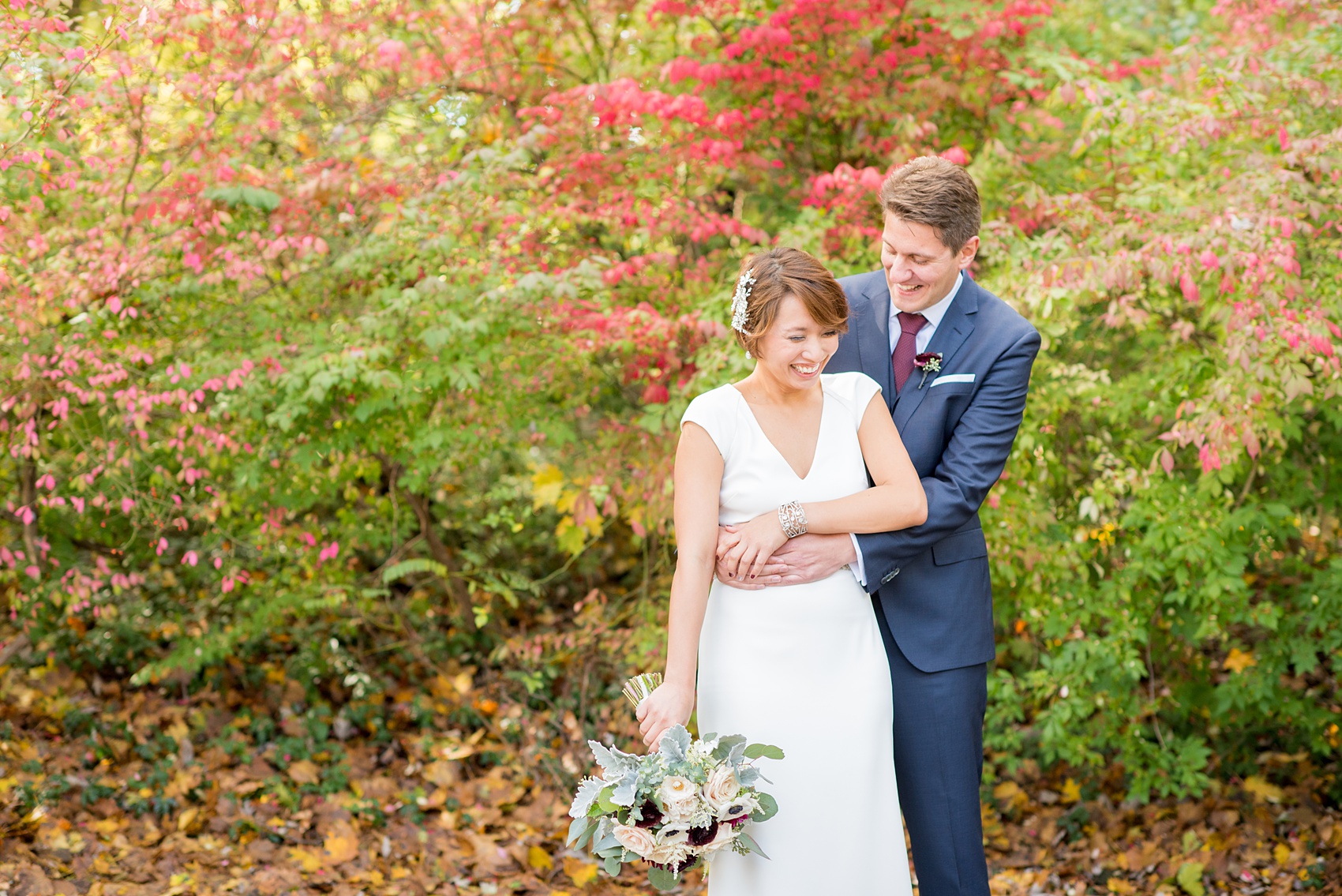 Mikkel Paige Photography photos of a wedding at Crabtree's Kittle House in Chappaqua, New York. Photo of the bride and groom with autumn leaves.