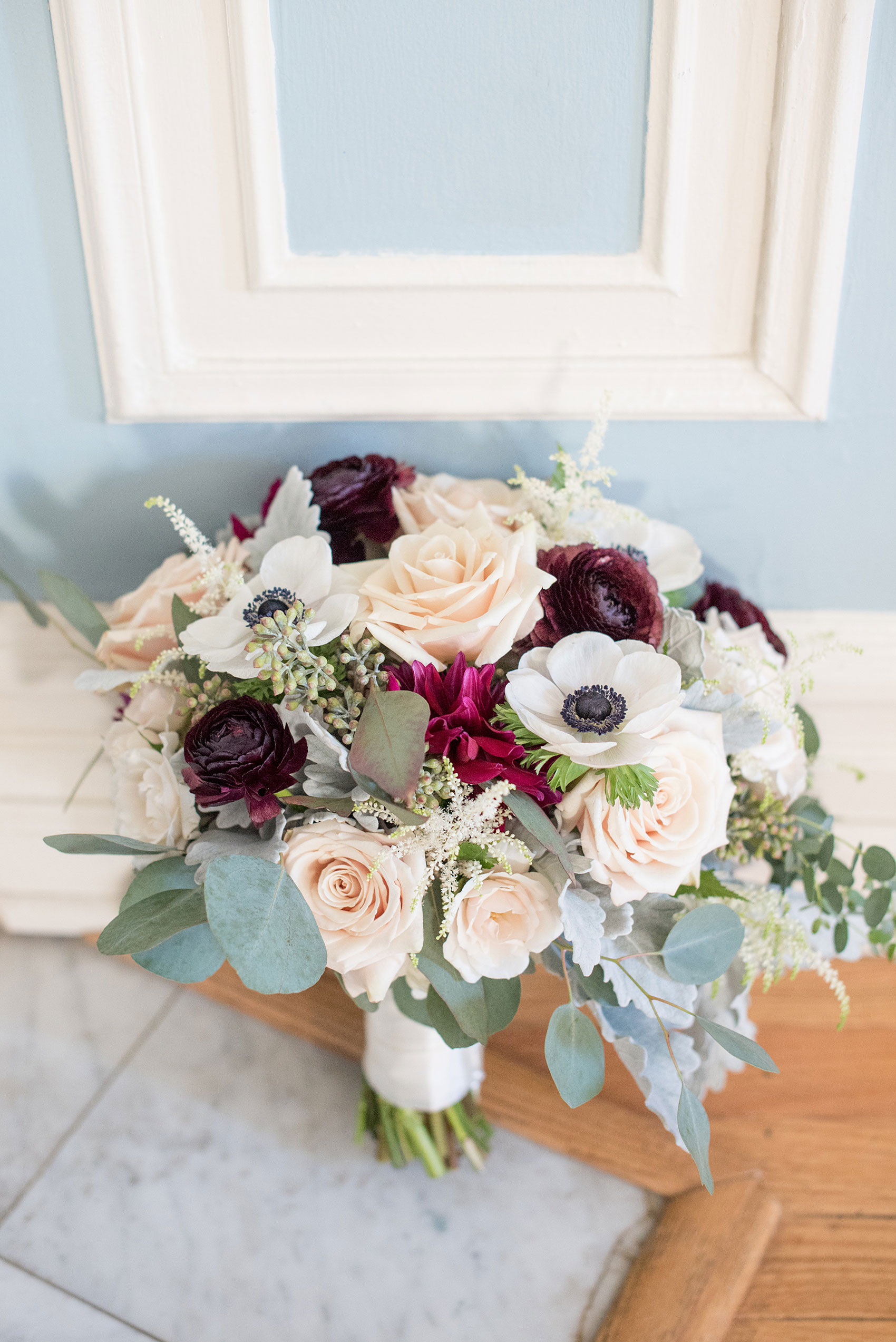 Mikkel Paige Photography photos of a wedding at Crabtree's Kittle House in Chappaqua, New York. Picture of the bride's fall inspired bouquet with dark red dahlias, white anemones and cream roses.