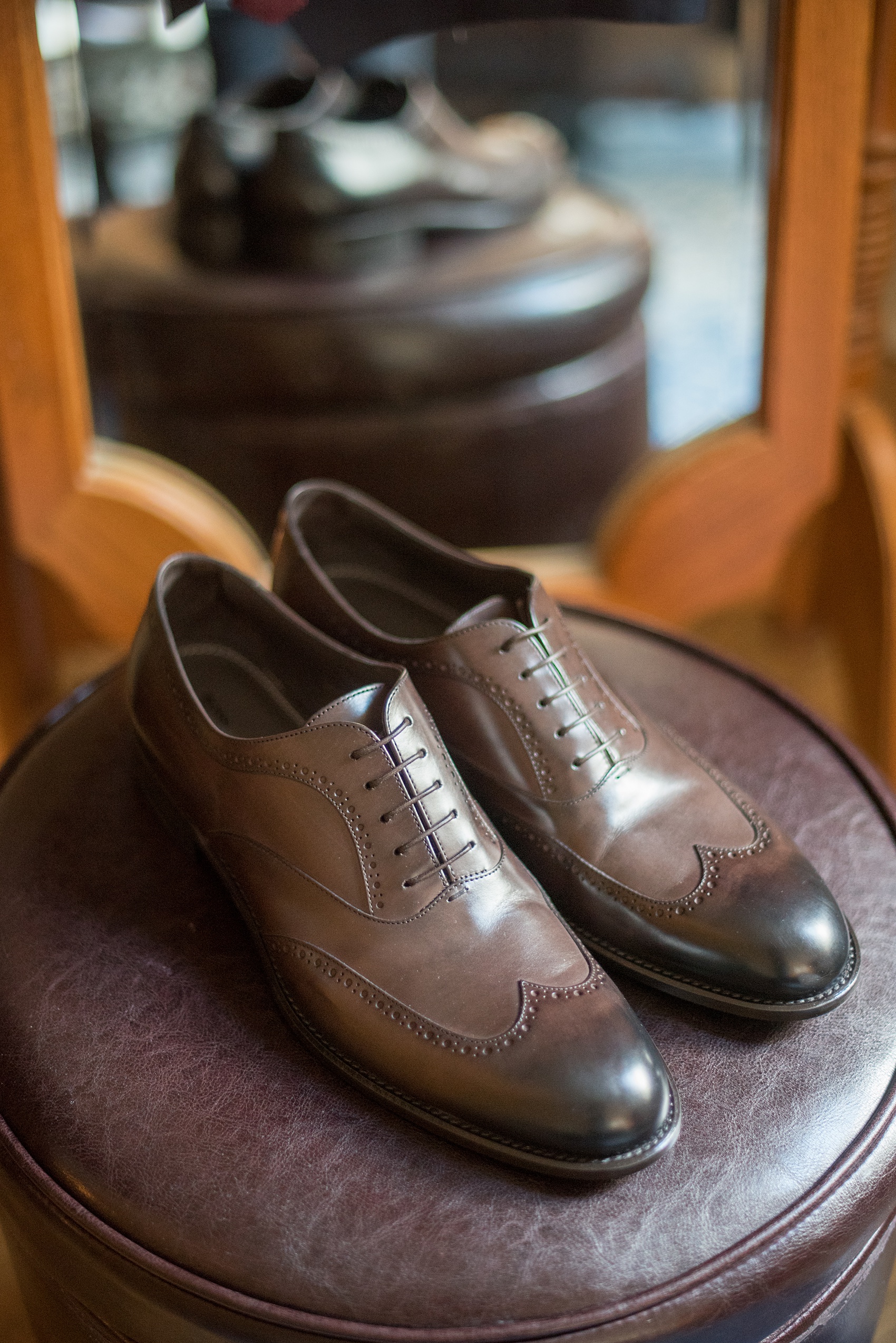 Mikkel Paige Photography photos of a wedding at Crabtree's Kittle House in Chappaqua, New York. Picture of the groom's dark brown leather dress shoes.