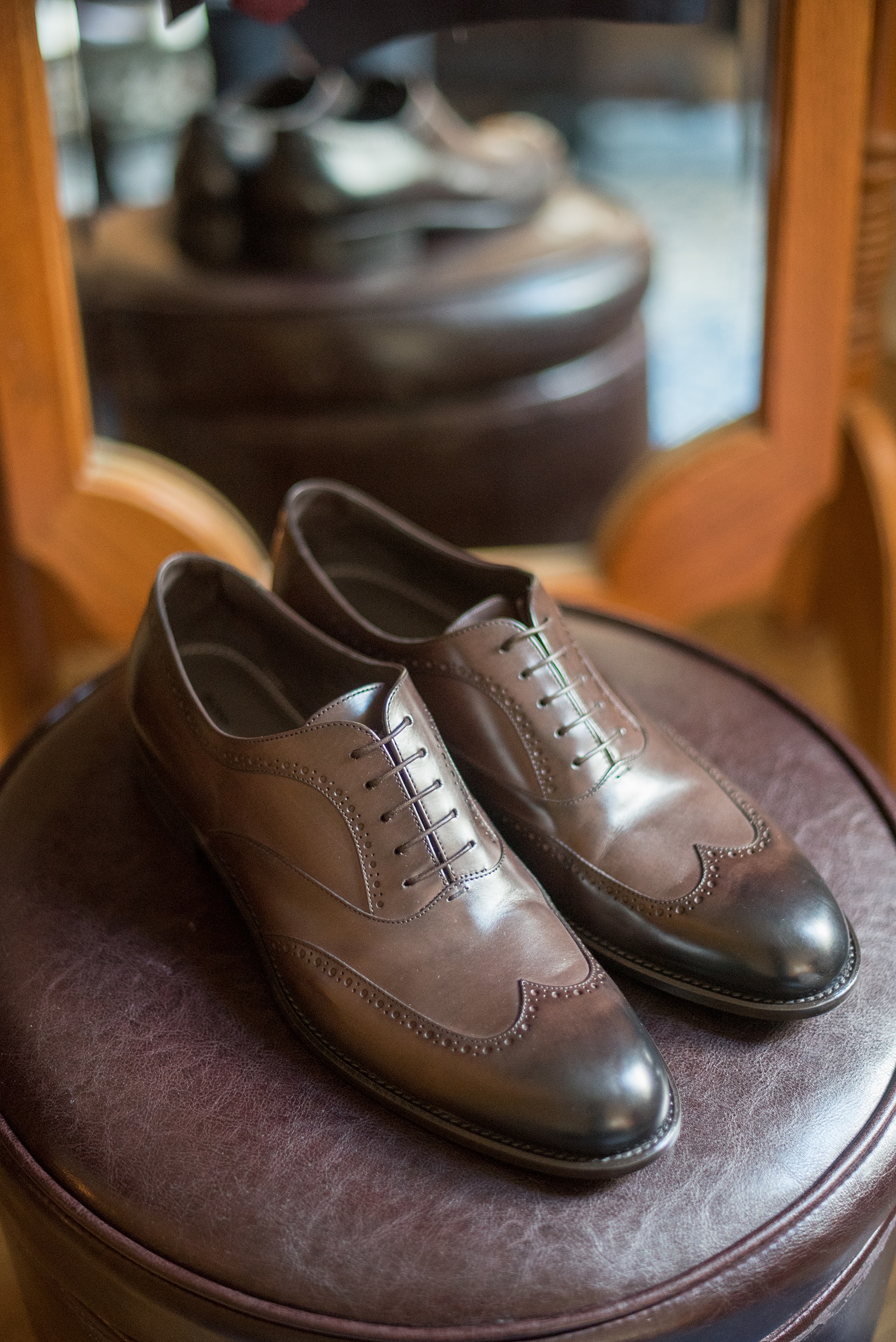Mikkel Paige Photography photos of a wedding at Crabtree's Kittle House in Chappaqua, New York. Picture of the groom's dark brown leather dress shoes.