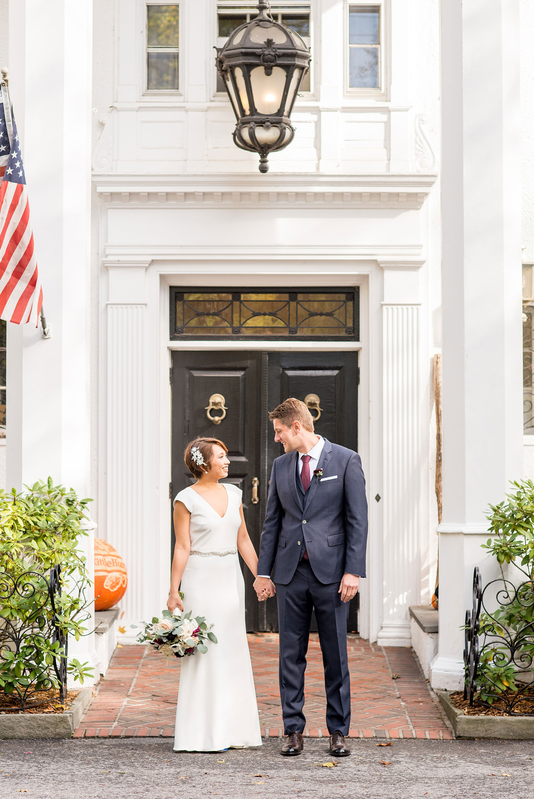 Mikkel Paige Photography photos of a wedding at Crabtree's Kittle House in Chappaqua, New York. Picture of the bride and groom in front of the historic NY home.