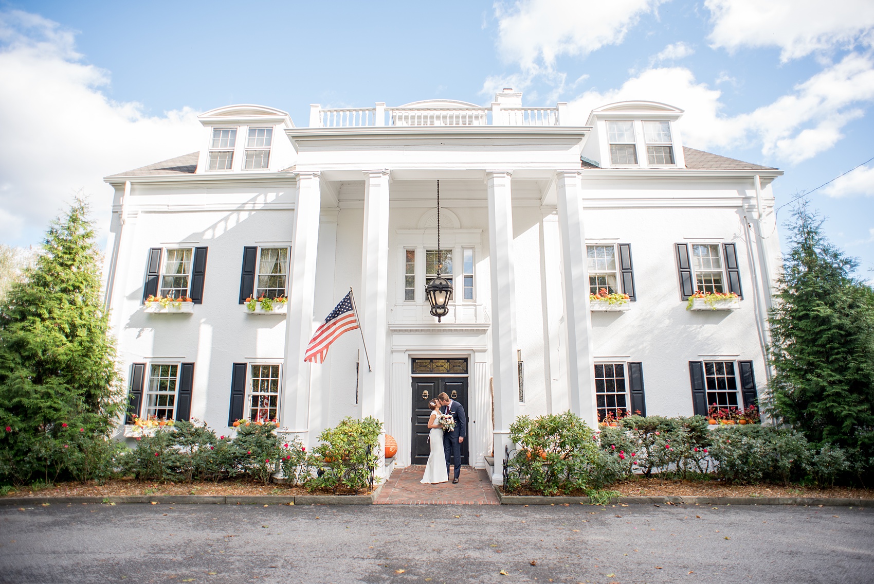 Mikkel Paige Photography photos of a wedding at Crabtree's Kittle House in Chappaqua, New York. Picture of the bride and groom in front of the historic NY home.