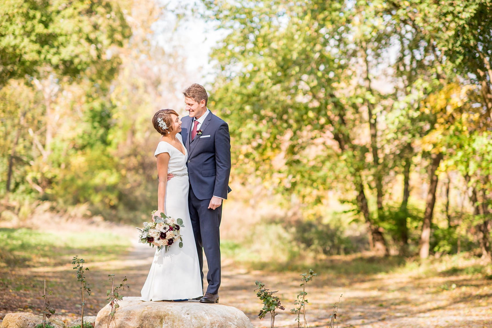 Mikkel Paige Photography photos of a wedding at Crabtree's Kittle House in Chappaqua, New York. Photo of the bride and groom with autumn leaves.