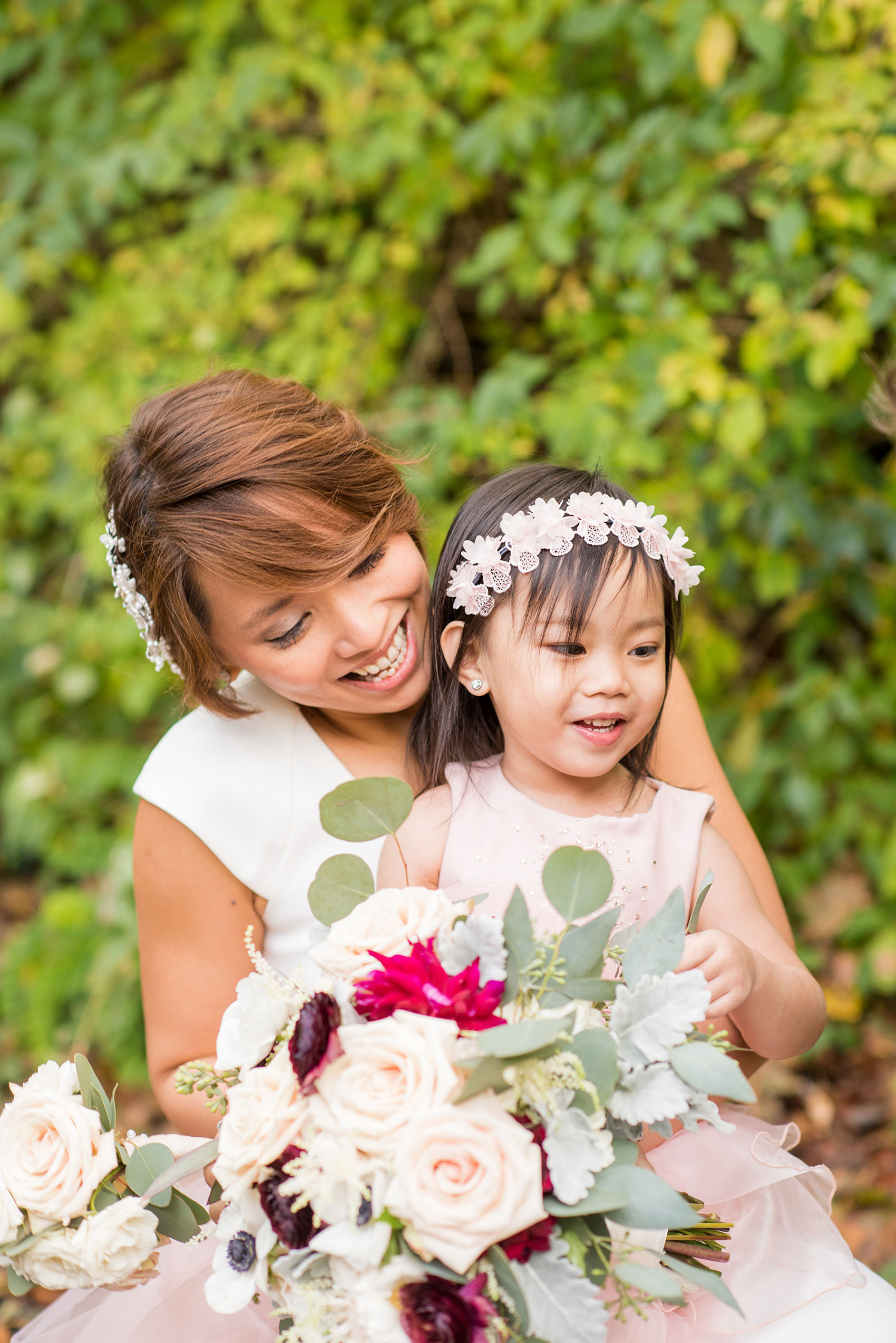 Mikkel Paige Photography photos of a wedding at Crabtree's Kittle House in Chappaqua, New York. Picture of the bride with her niece, a flower girl in a pink dress.