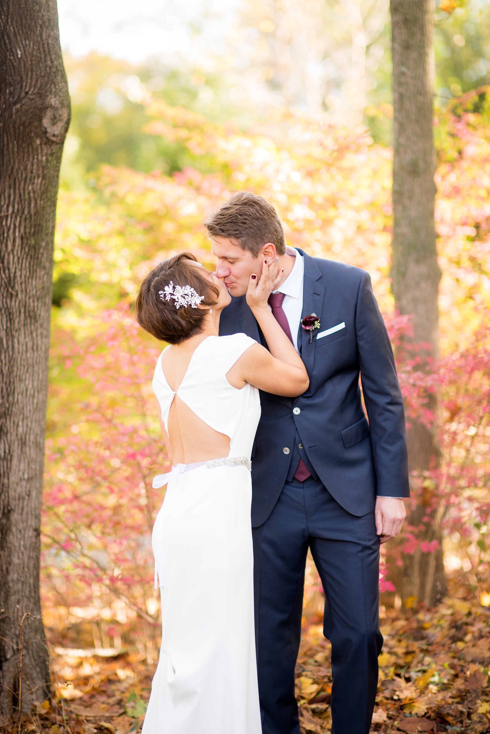 Mikkel Paige Photography photos of a wedding at Crabtree's Kittle House in Chappaqua, New York. Photo of the bride and groom with autumn leaves.