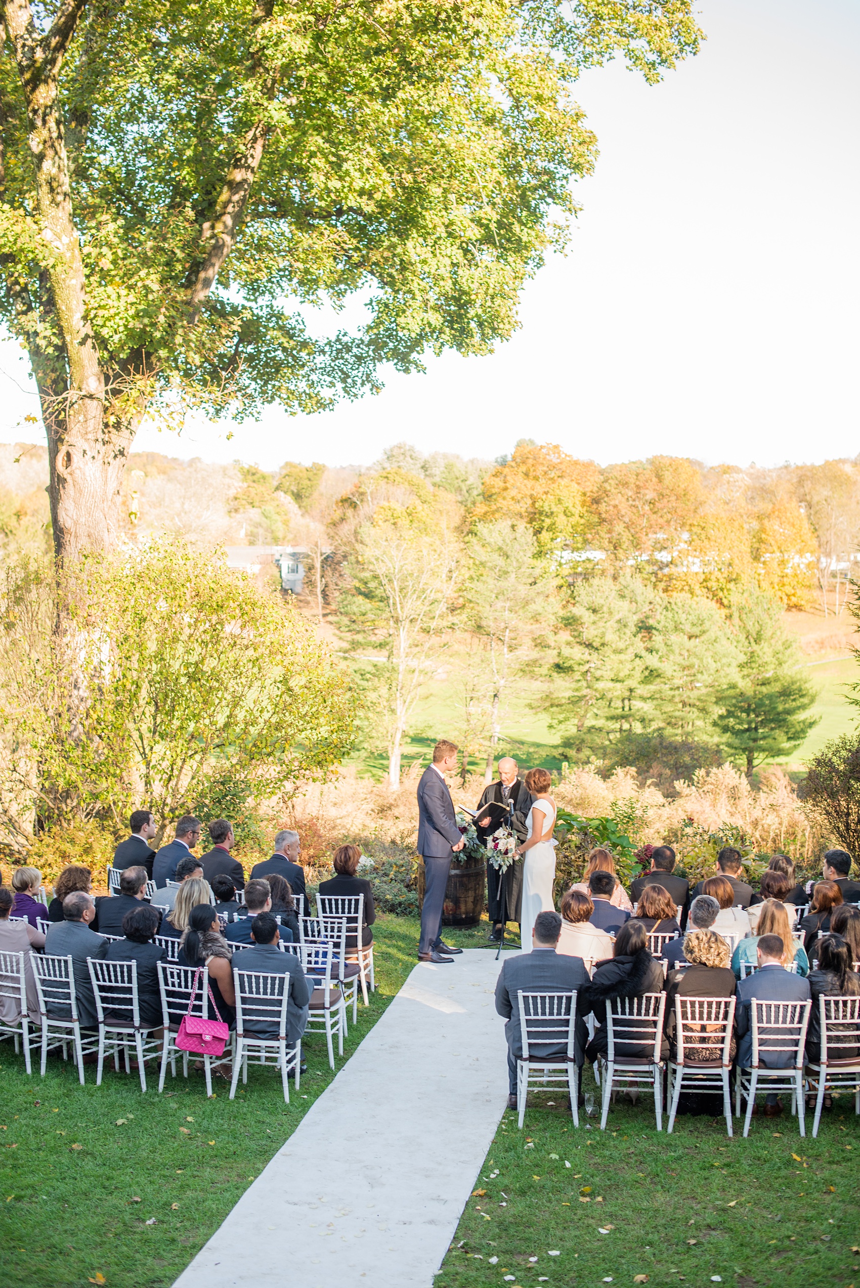 Mikkel Paige Photography photos of a wedding at Crabtree's Kittle House in Chappaqua, New York. Picture of the couple's outdoor fall ceremony. 