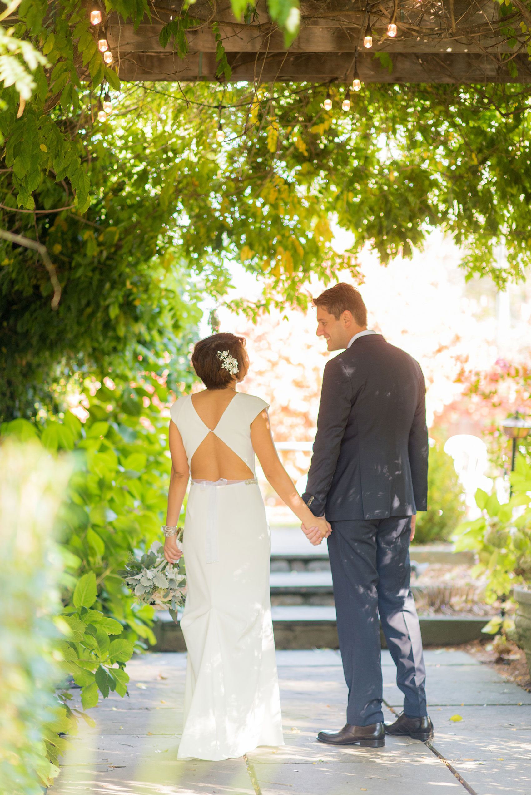 Mikkel Paige Photography photos of a wedding at Crabtree's Kittle House in Chappaqua, New York. Picture of the couple's walking away to the outdoor garden.