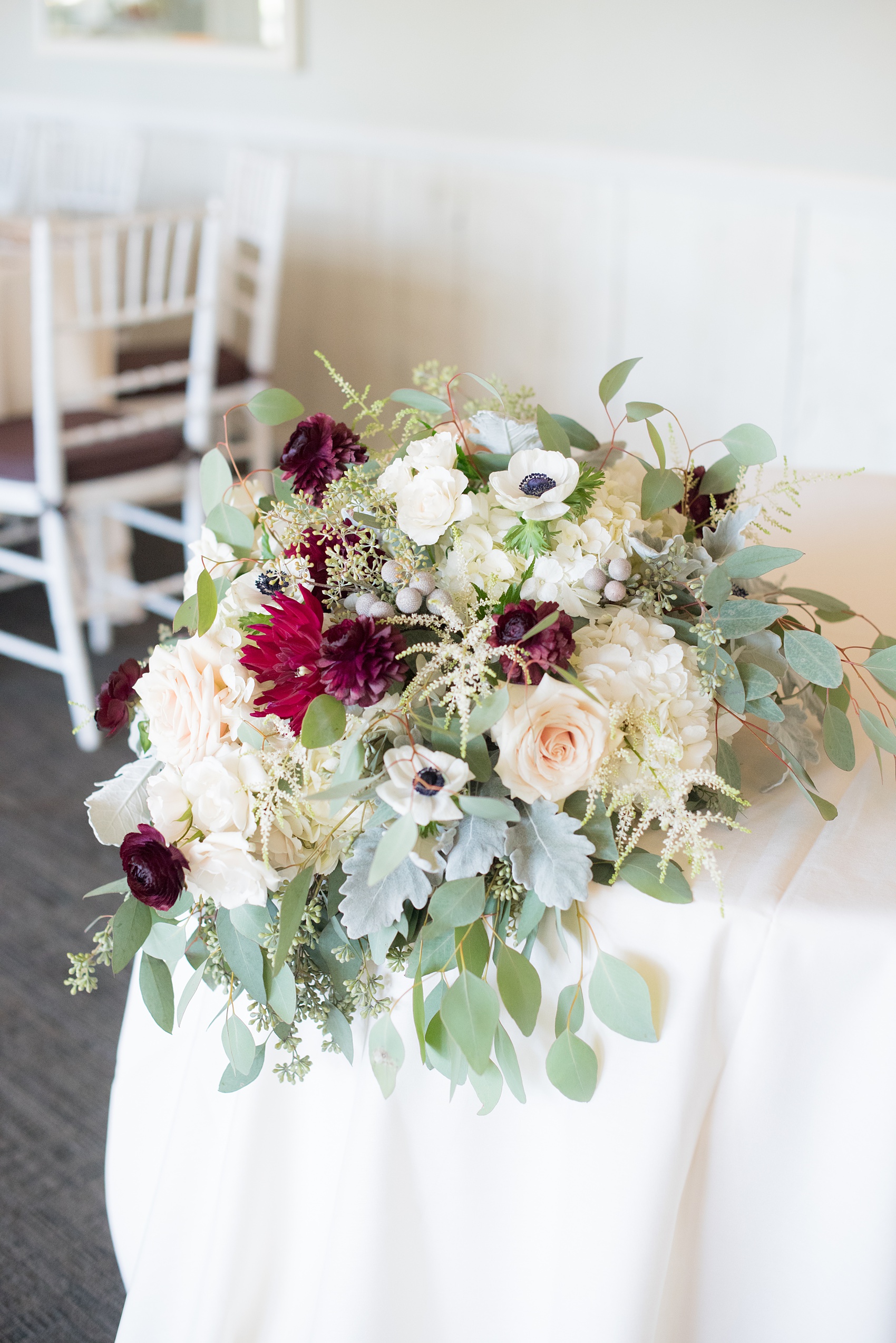 Mikkel Paige Photography photos of a wedding at Crabtree's Kittle House in Chappaqua, New York. Picture of the fall flowers on the sweetheart table.