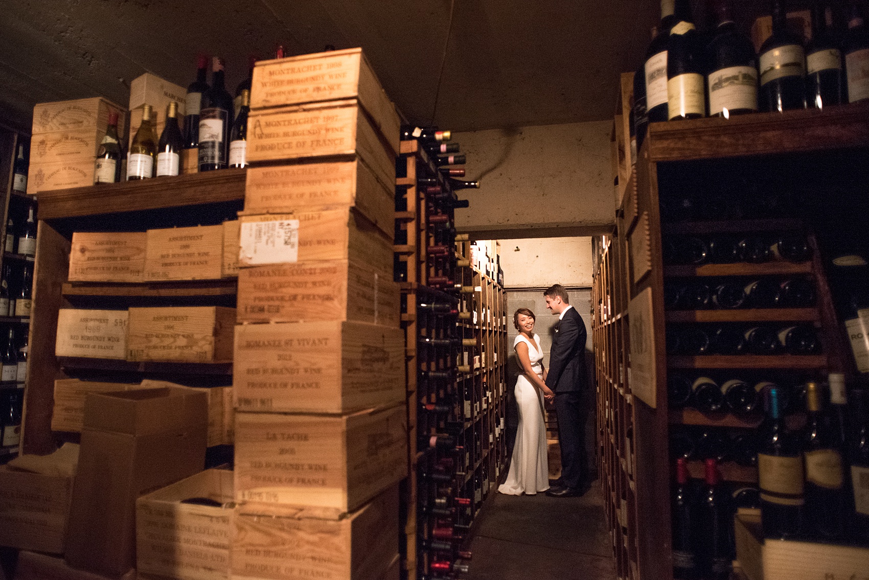 Mikkel Paige Photography photos of a wedding at Crabtree's Kittle House in Chappaqua, New York. Picture of the bride and groom in the wine cellar.