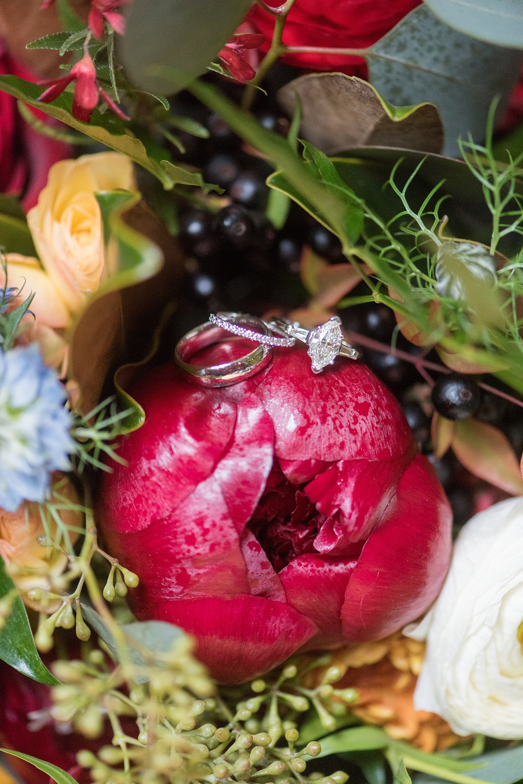 Beautiful wedding photos at The Carolina Inn at Chapel Hill, North Carolina by Mikkel Paige Photography. Detail photo of the bride unique diamond marquee engagement ring and wedding bands. Click through to see the rest of this gorgeous winter wedding! #thecarolinainn Flowers by English Garden.