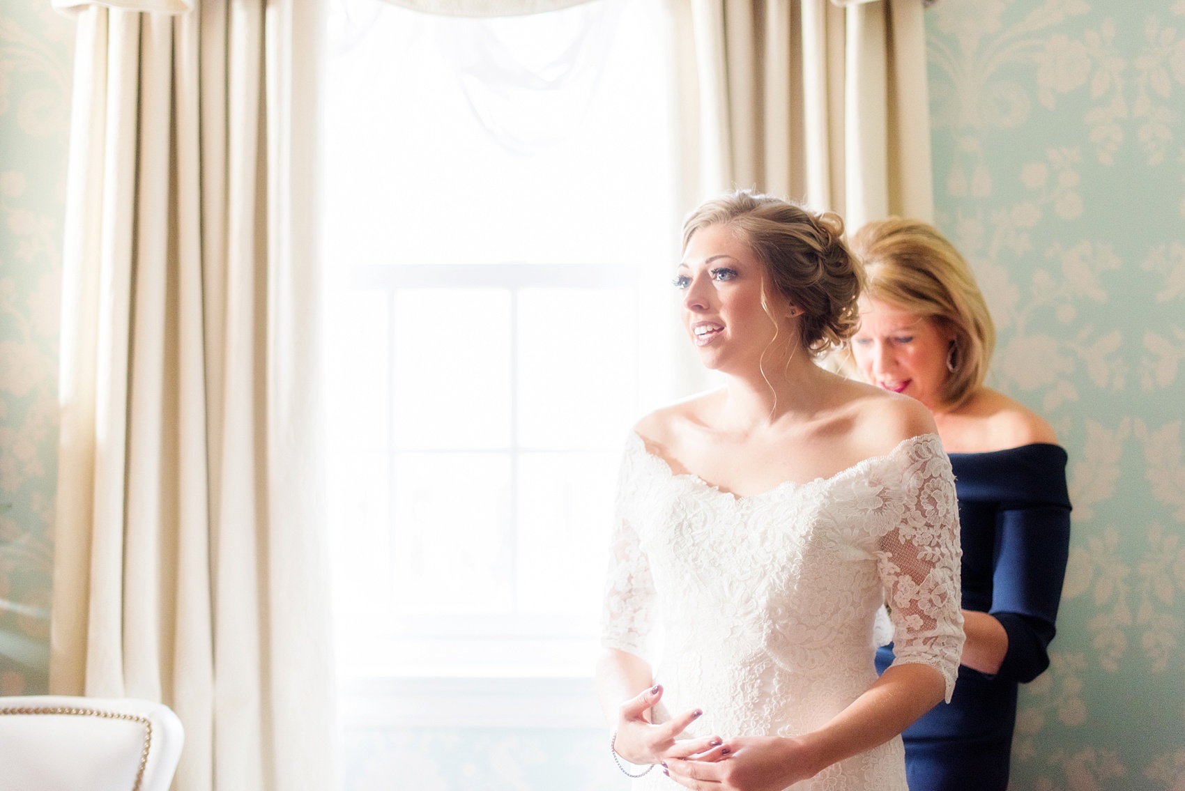 Beautiful wedding photos at The Carolina Inn at Chapel Hill, North Carolina by Mikkel Paige Photography. Photo of the bride's mother helping her get into her wedding gown - click through to see the rest of this gorgeous winter wedding! #thecarolinainn