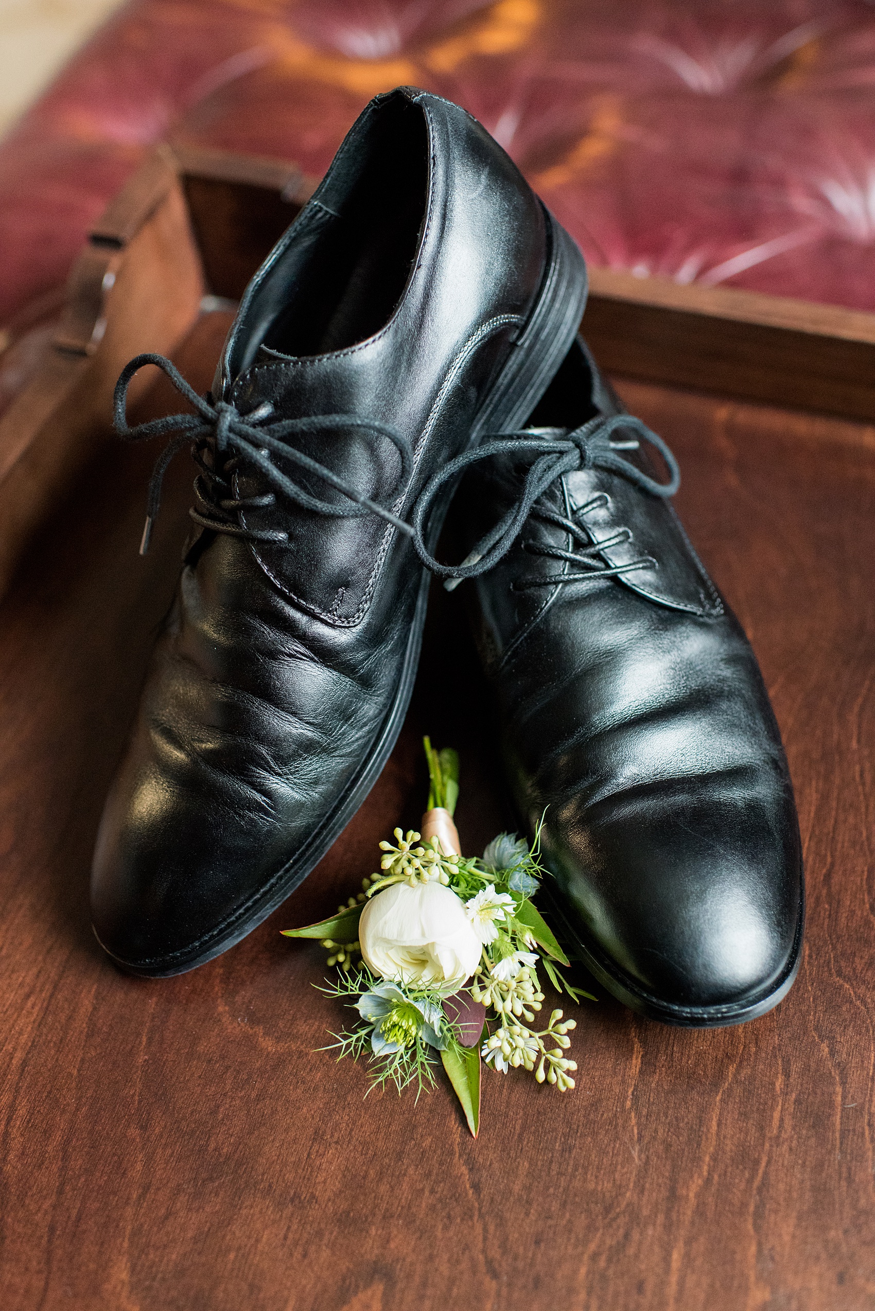 Beautiful wedding photos at The Carolina Inn at Chapel Hill, North Carolina by Mikkel Paige Photography. Detail photo of the groom's wedding shoes and boutonniere. Click through to see the rest of this gorgeous winter wedding! #thecarolinainn #snowywedding