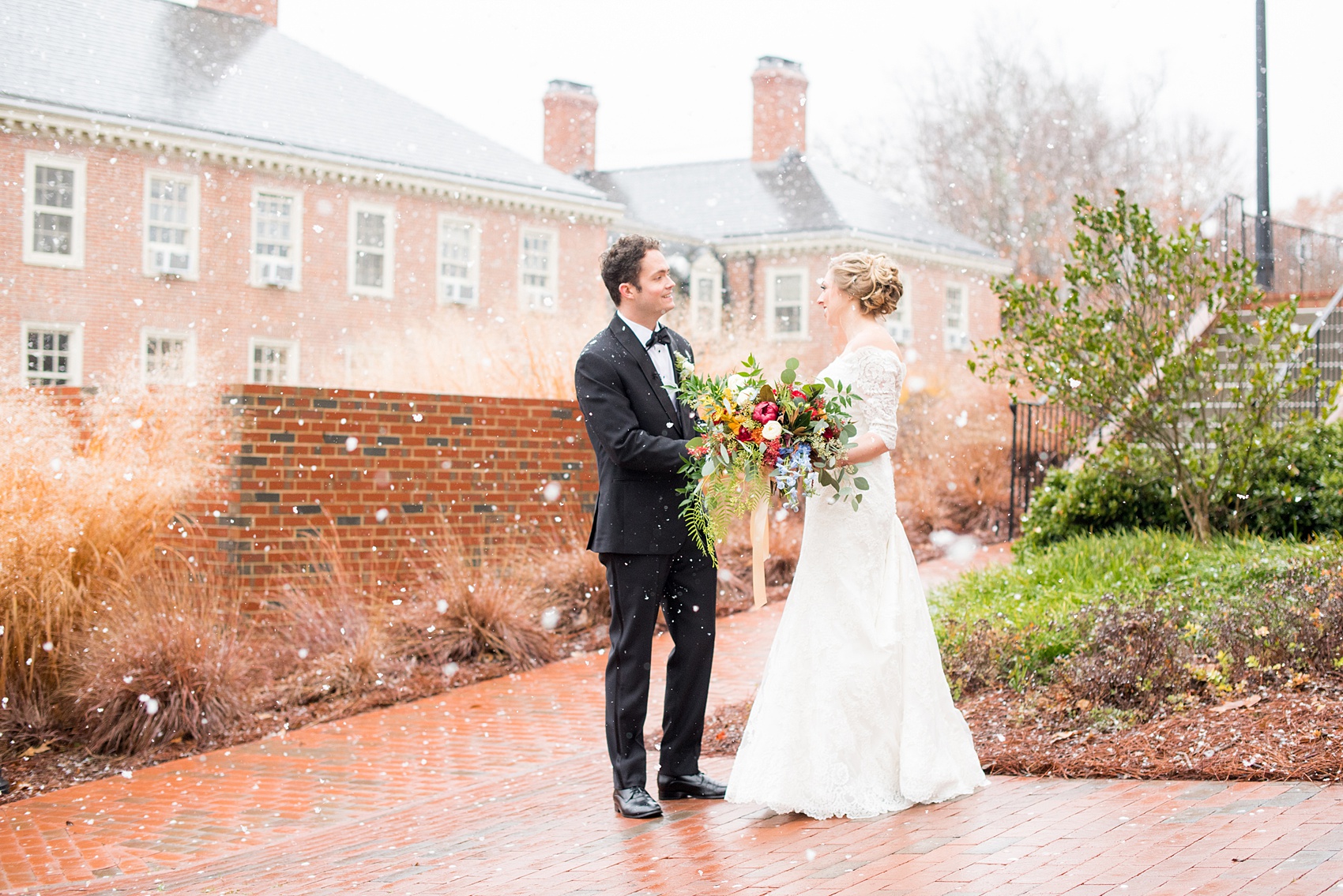 Beautiful wedding photos at The Carolina Inn at Chapel Hill, North Carolina by Mikkel Paige Photography. The bride walked through falling snow for their winter wonderland first look! Click through to see the rest of this gorgeous winter wedding! #thecarolinainn #snowywedding