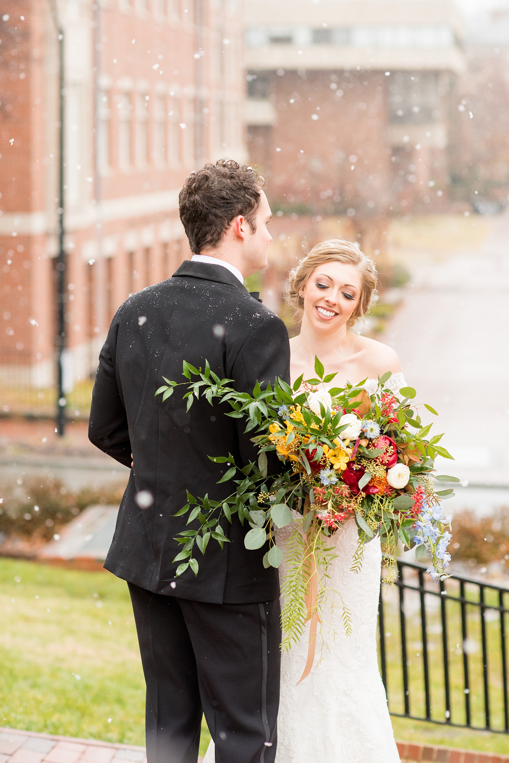 Beautiful wedding photos at The Carolina Inn at Chapel Hill, North Carolina by Mikkel Paige Photography. Photo of the bride and groom in the falling snow. Click through to see the rest of this gorgeous winter wedding! #thecarolinainn #snowywedding