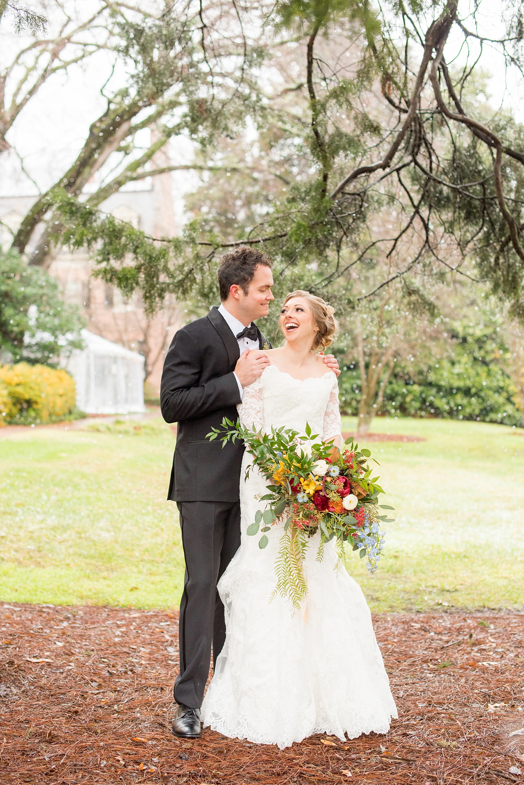 Beautiful wedding photos at The Carolina Inn at Chapel Hill, North Carolina by Mikkel Paige Photography. Photo of the bride and groom laughing through the falling snow. Click through to see the rest of this gorgeous winter wedding! #thecarolinainn #snowywedding